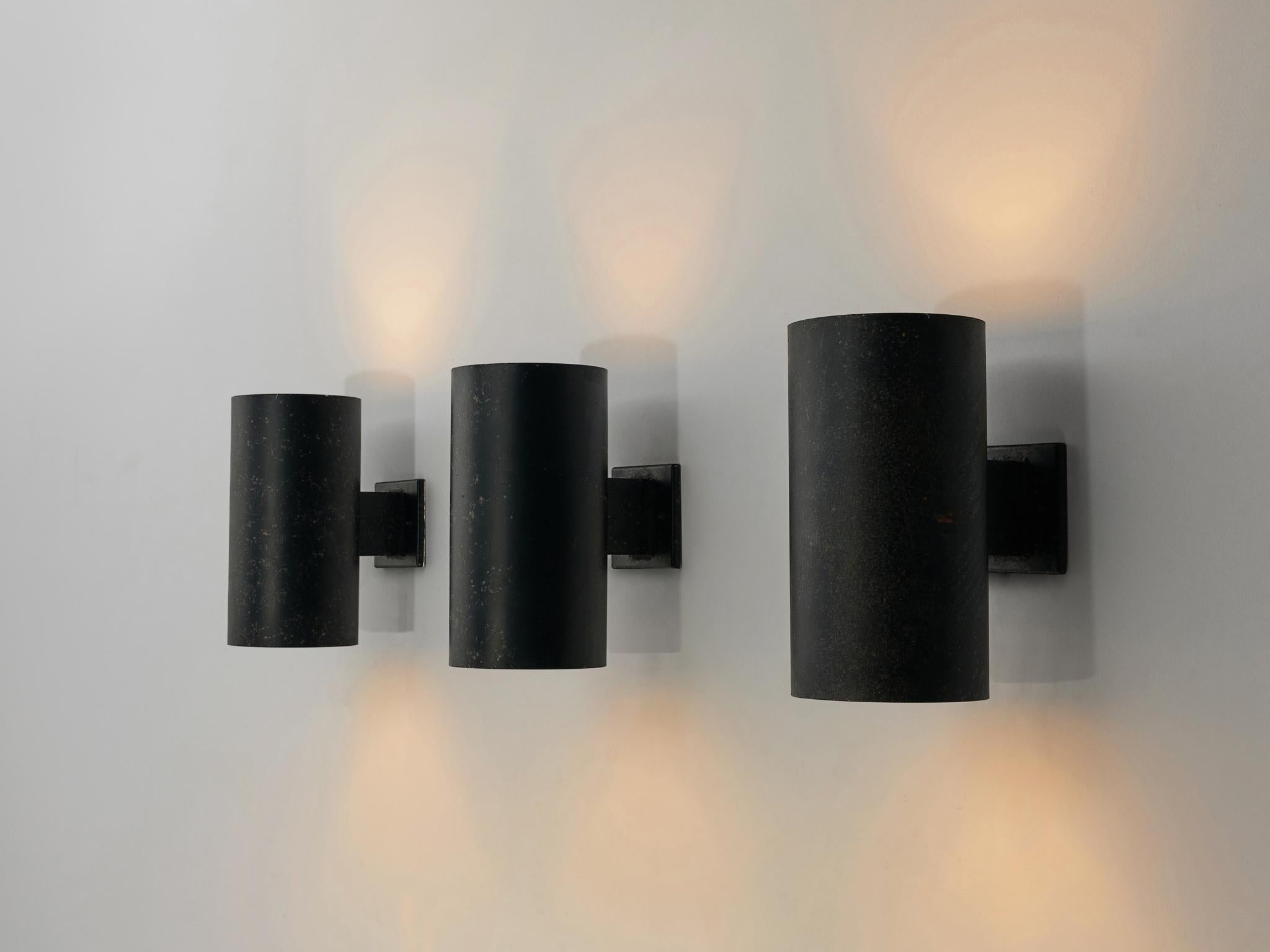 Louis Poulsen, wall lamps, lacquered metal, Denmark, 1950s

Wall lights by manufacturer Louis Poulsen. The lights have a strong simple shape. The black metal cones have a beautiful patina. Because of the cylindrical open shape of the lamp the