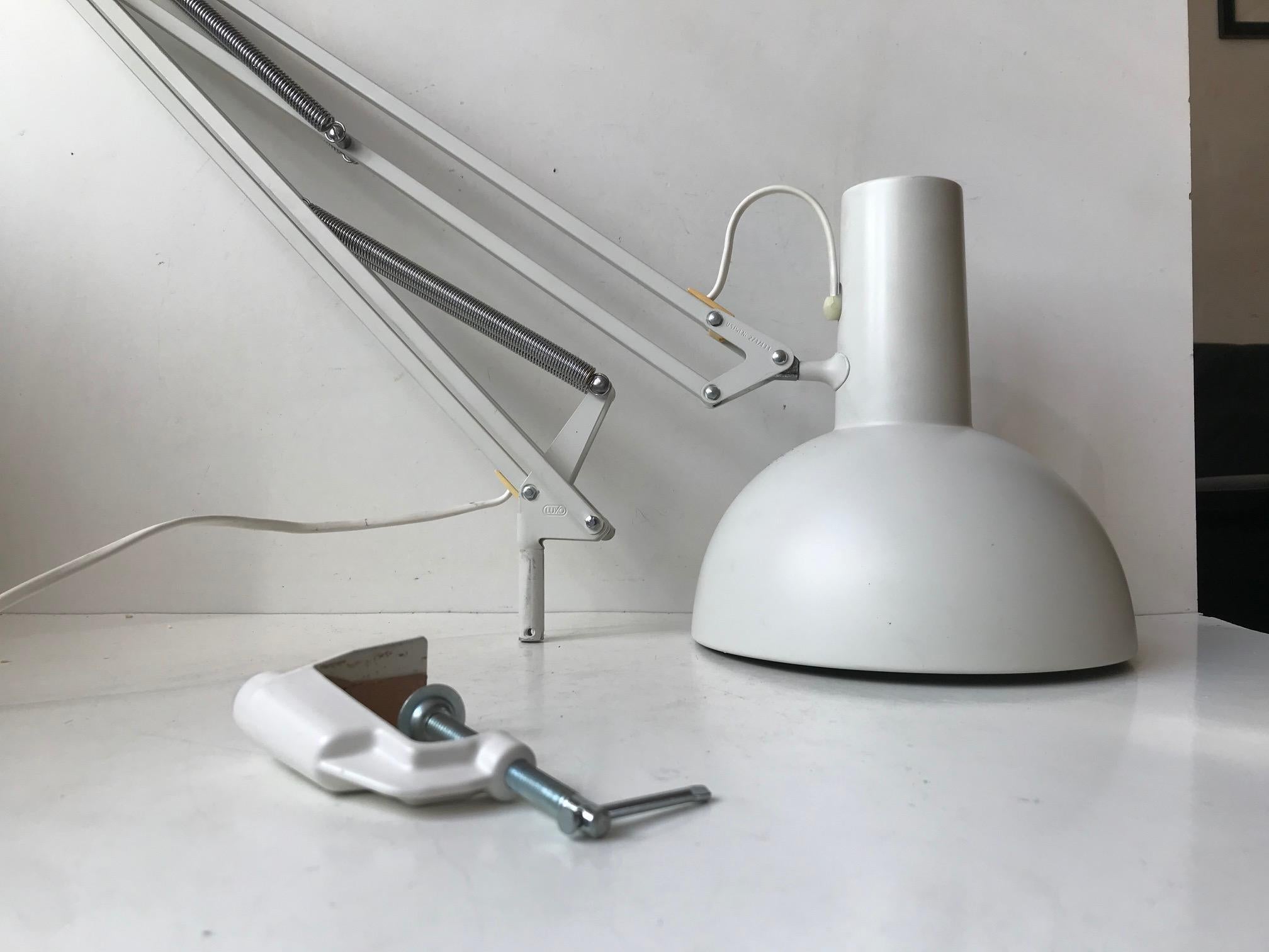 Often referred to as 'The Ghost of PH' and based on the Ideas of Poul Henningsen this fully adjustable white 'Anglepoise' desk light was designed in-house at Louis Poulsen in the early 1970s. This one is an dates from the 80s. It comes with LP