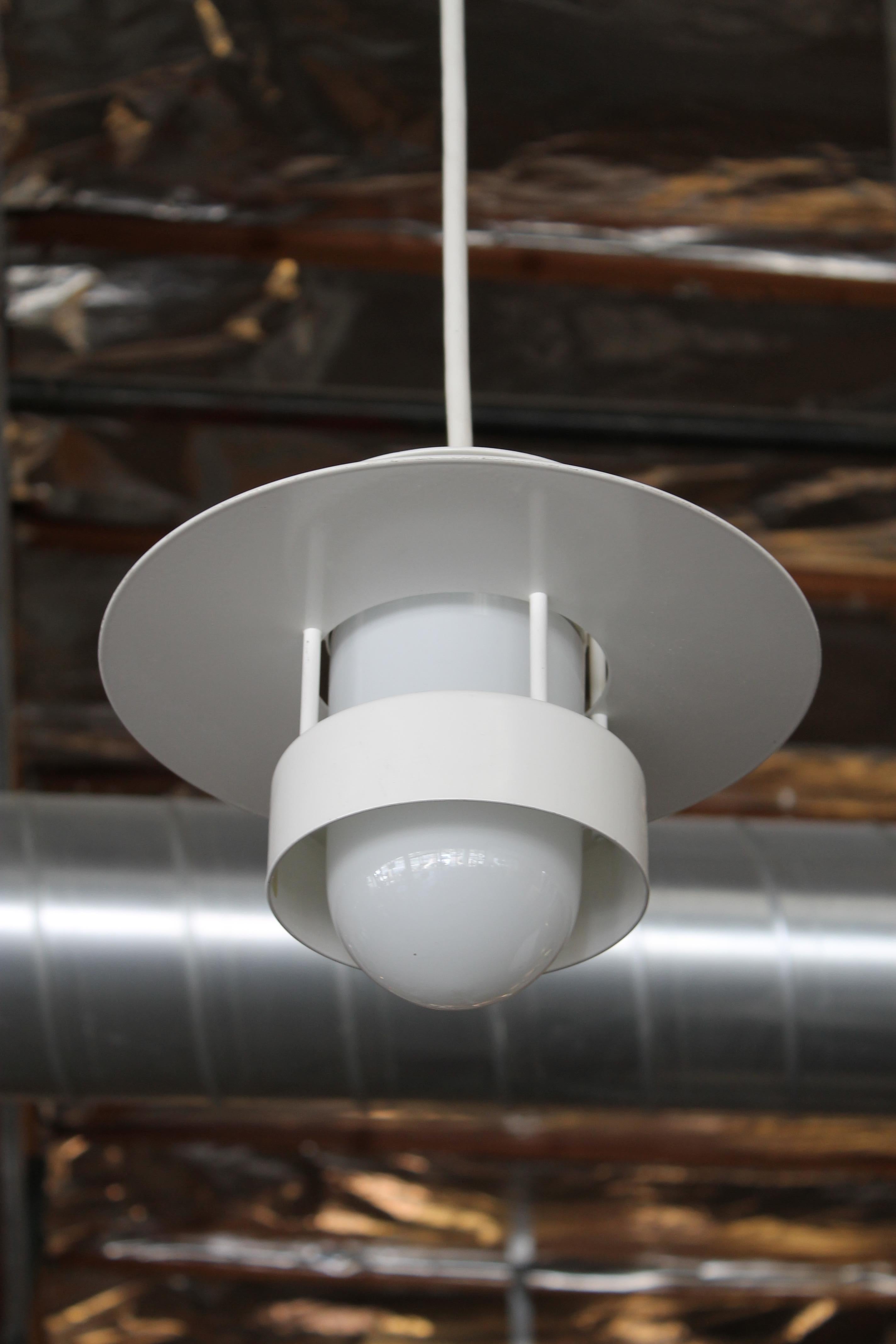 White pendant by Louis Poulsen for the Poulsen Lighting Company. Pendant has been rewired and can accommodate an LED, incandescent or compact fluorescent bulb. Number on label says looks 99-09 which we assume is the year 1999. Cord is 40