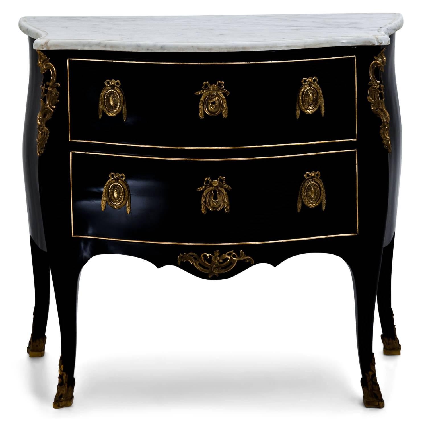 Two-drawered Louis Quinze chest of drawers with an ebonized trapezoidal body and white marble top as well as bronze fittings. The chest was later ebonized.