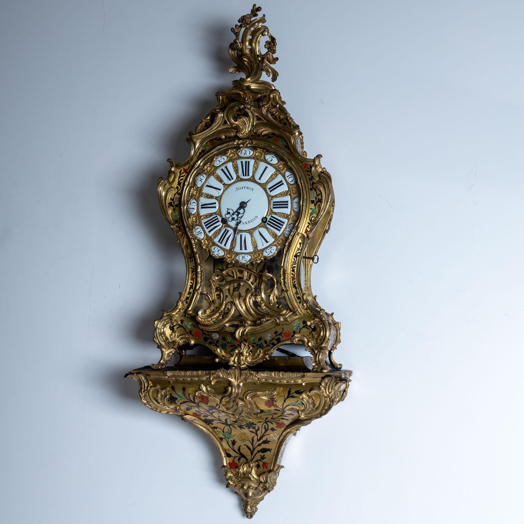 Large Cartel Clock signed Joffroy of Besançon (clockmaker active around 1760) and Balthazar Lieutaud (ébéniste, 1720–1780) with an enameled dial featuring Roman numerals for the hours and Arabic numerals for the minutes. The elaborate design