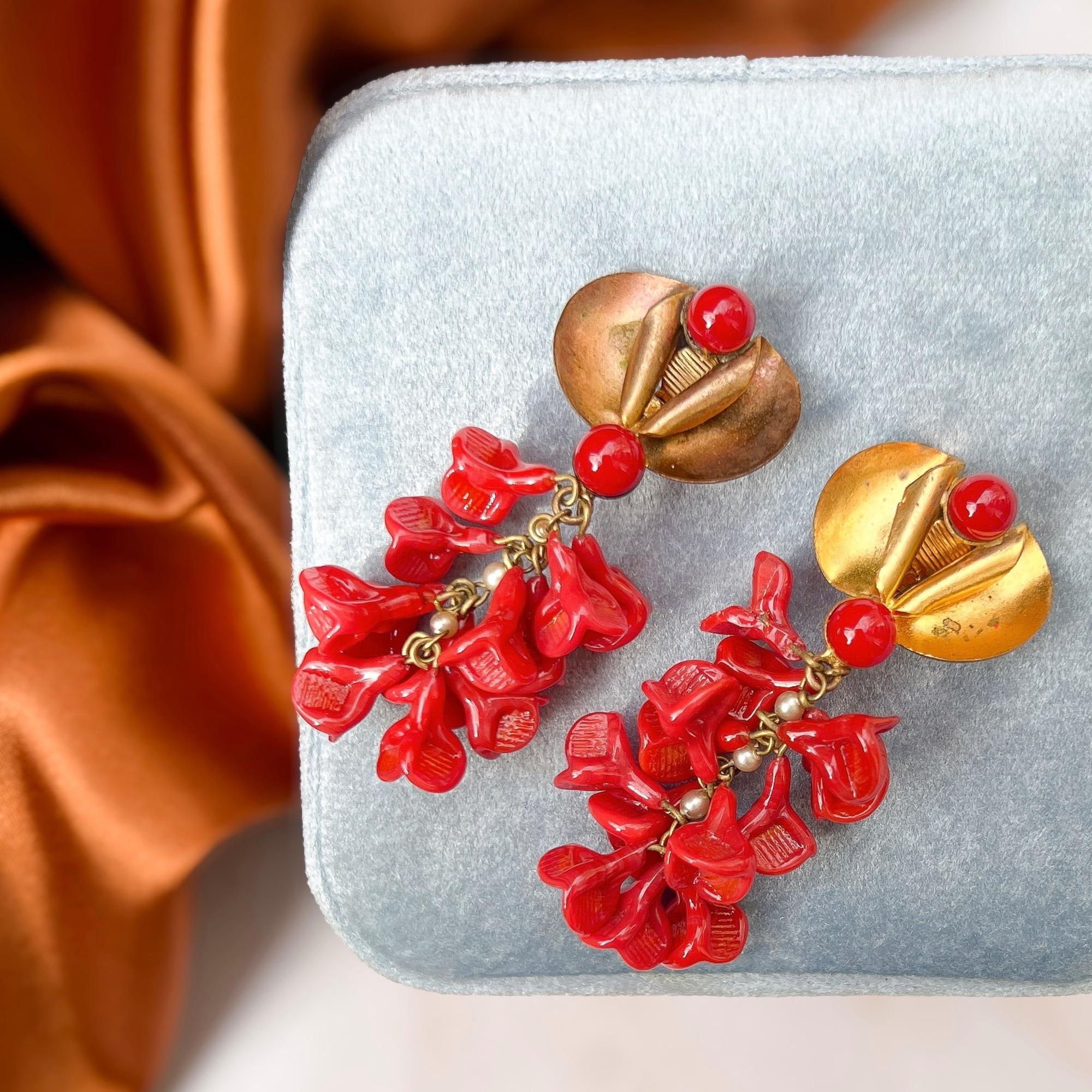 Featuring delicate and pretty glass flowers, these earrings date from the 1950s and was created in France by the Louis Rousselet company for the designer Madeleine Rivière.

Condition Report:
Good - One of the floral drops is missing a petal and the