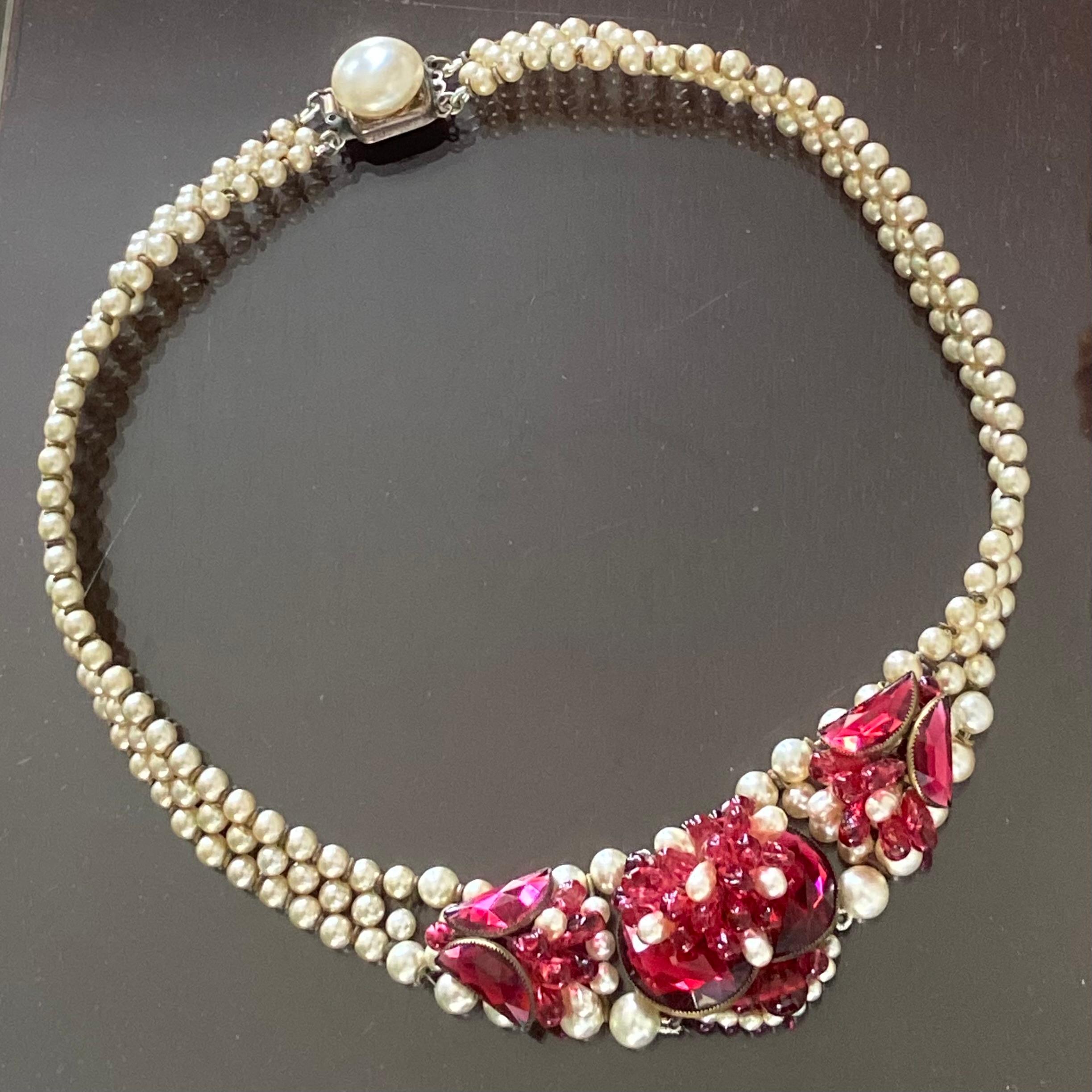 This is a real beauty.

So iconically Louis Rousselet craftsmanship.

There is a  triple row of wired Rousselet glass pearls with a central panel set with fuchsia Demi-lune crystals with fuchsia and pearl poured glass drops. The back of the centre