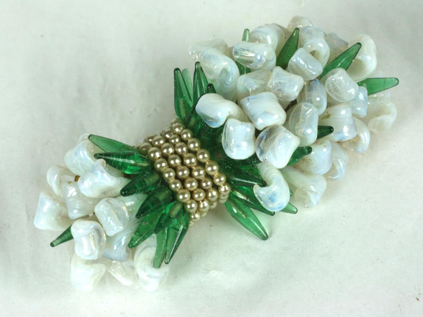 Louis Rousselet  large brooch of signature hand made and hand wired curling opaline glass petals and leaves with deep emerald stamens of pate de verre.  Further wrapped and tied with hand made nacre seed pearls. 
Handmade. Gilt metal findings and