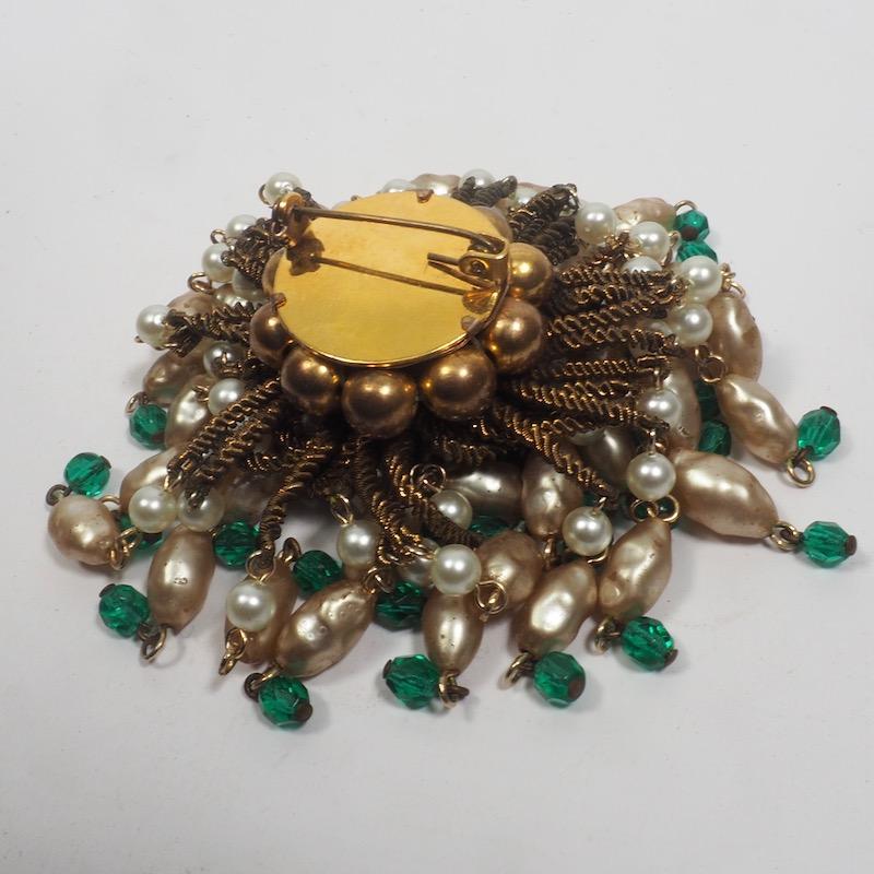 Louis Rousselet Nacre Pearl and Patte de Verre Brooch with tassle swags of long pendant nacre pearls and emerald glass beads surrounding a central gold and silver glittered orb. Rousselet was renowned in Paris for his spectacular costume jewellry
