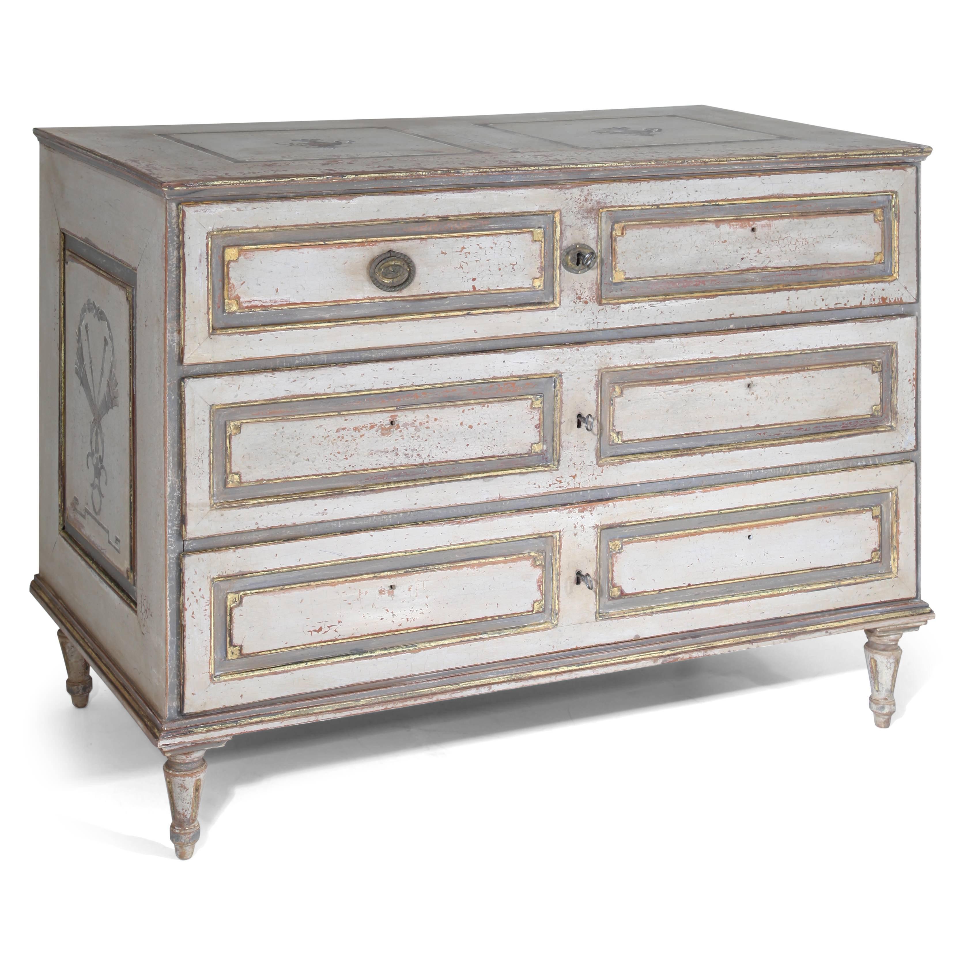 Three-drawered Louis Seize chest of drawers on conical fluted feet with fillings on the front and on the sides. The grey paint was redone and has an aged finish.
