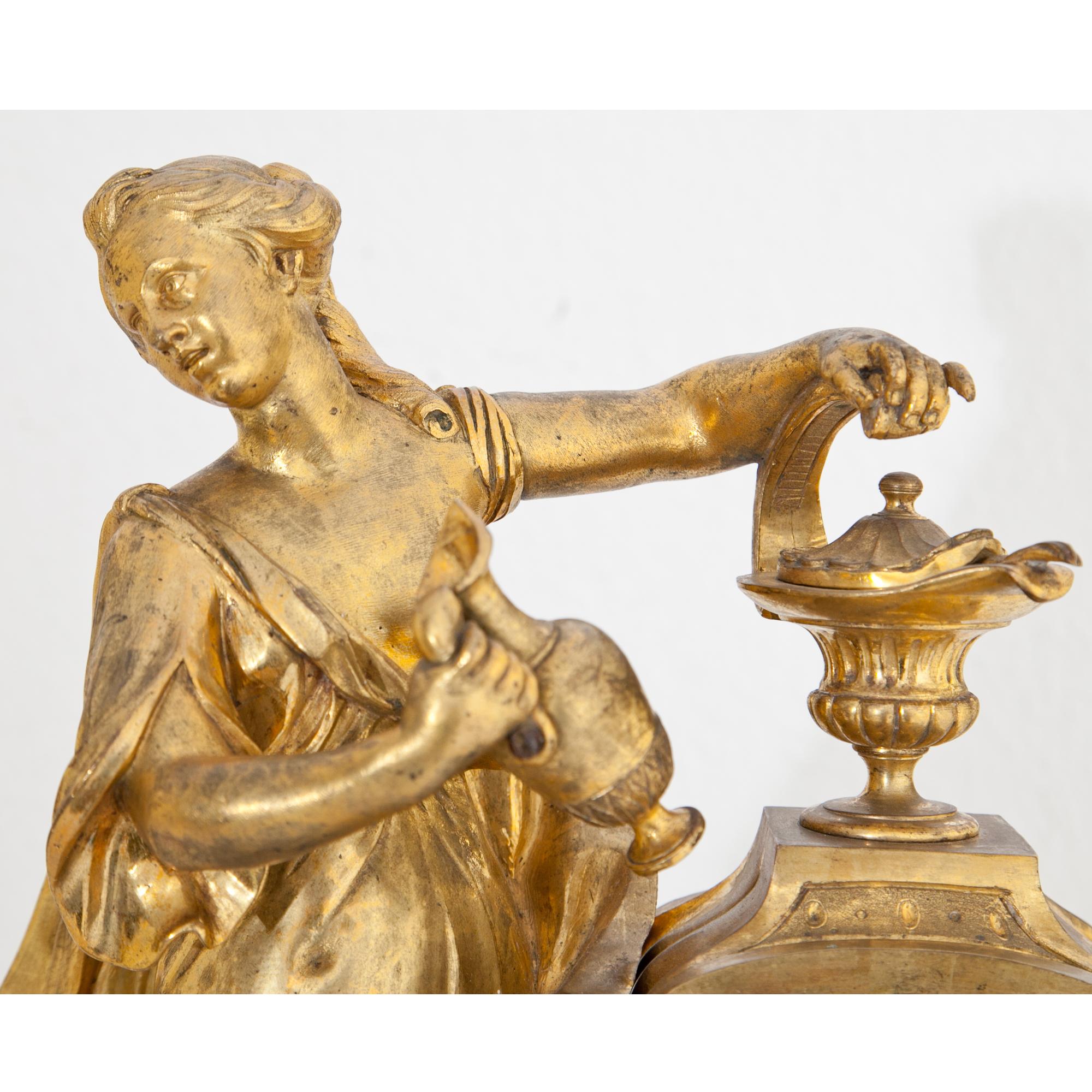 French Louis Seize Pendule clock on a white marble base above cone feet. The figurative depiction shows Psyche while filling the oil lamp, before she comes at night to her lover Amor. Inscribed on the enamel clockface ‘Cronier à Pars’. The clockwork