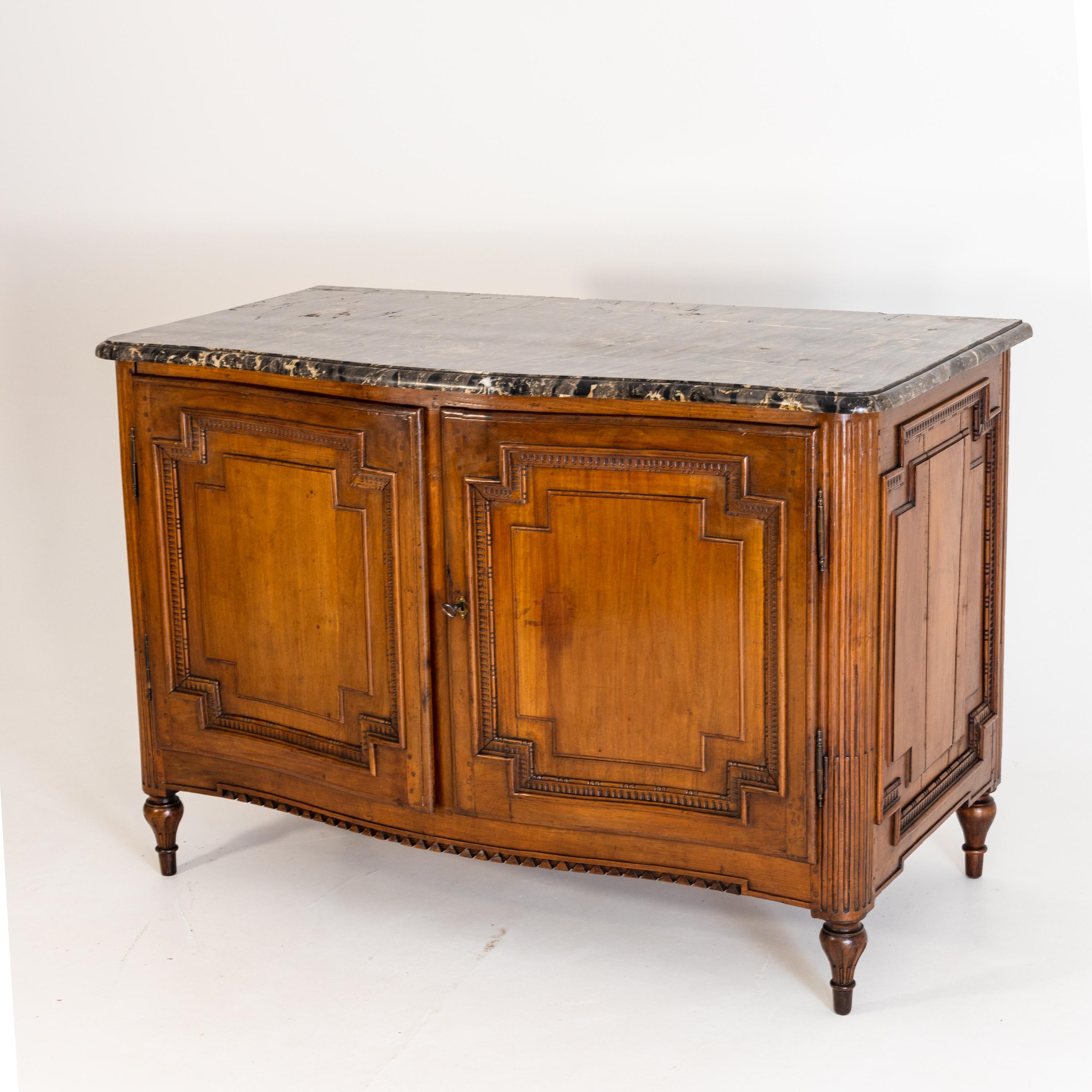 Two-door sideboard with slightly bulged front and beautiful original marble top. The body is coffered on all sides.