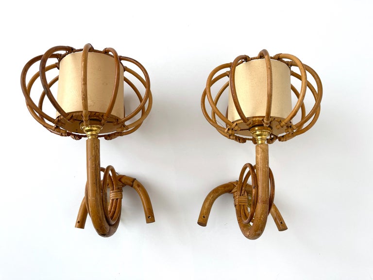 Louis Sognot “lantern” sconces
France, circa 1960’s 
Sculptural bamboo arm with torchiere original paper shade 
Original shade lining shows signs of age
Newly rewired.