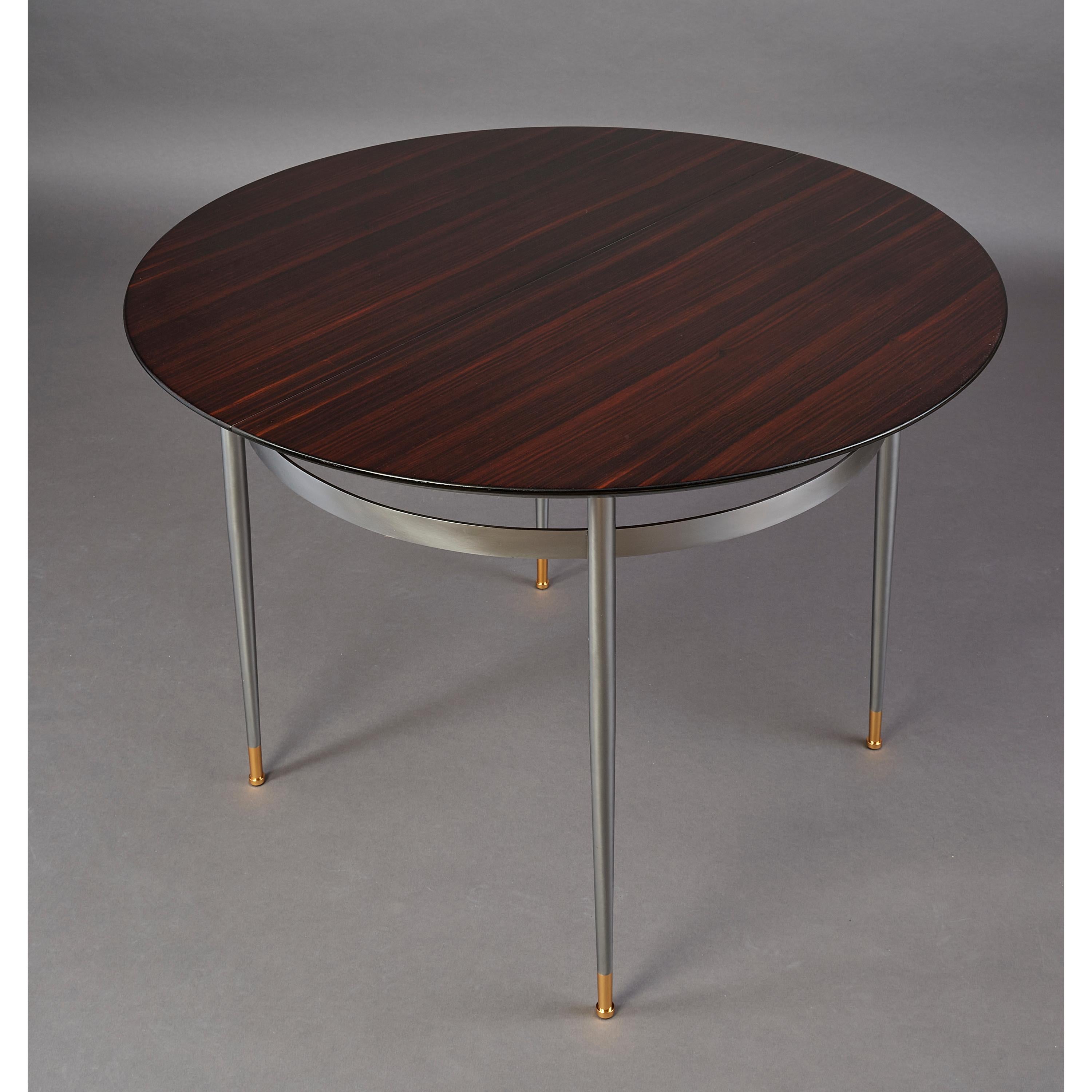 LOUIS SOGNOT (1892-1970) Edited by Maurice RINCK
An exceptional Modernist extendable center or dining table in Macassar Ebony, with tapered steel legs ending in polished bronze sabots. The table extends to become an exquisite oval table with one