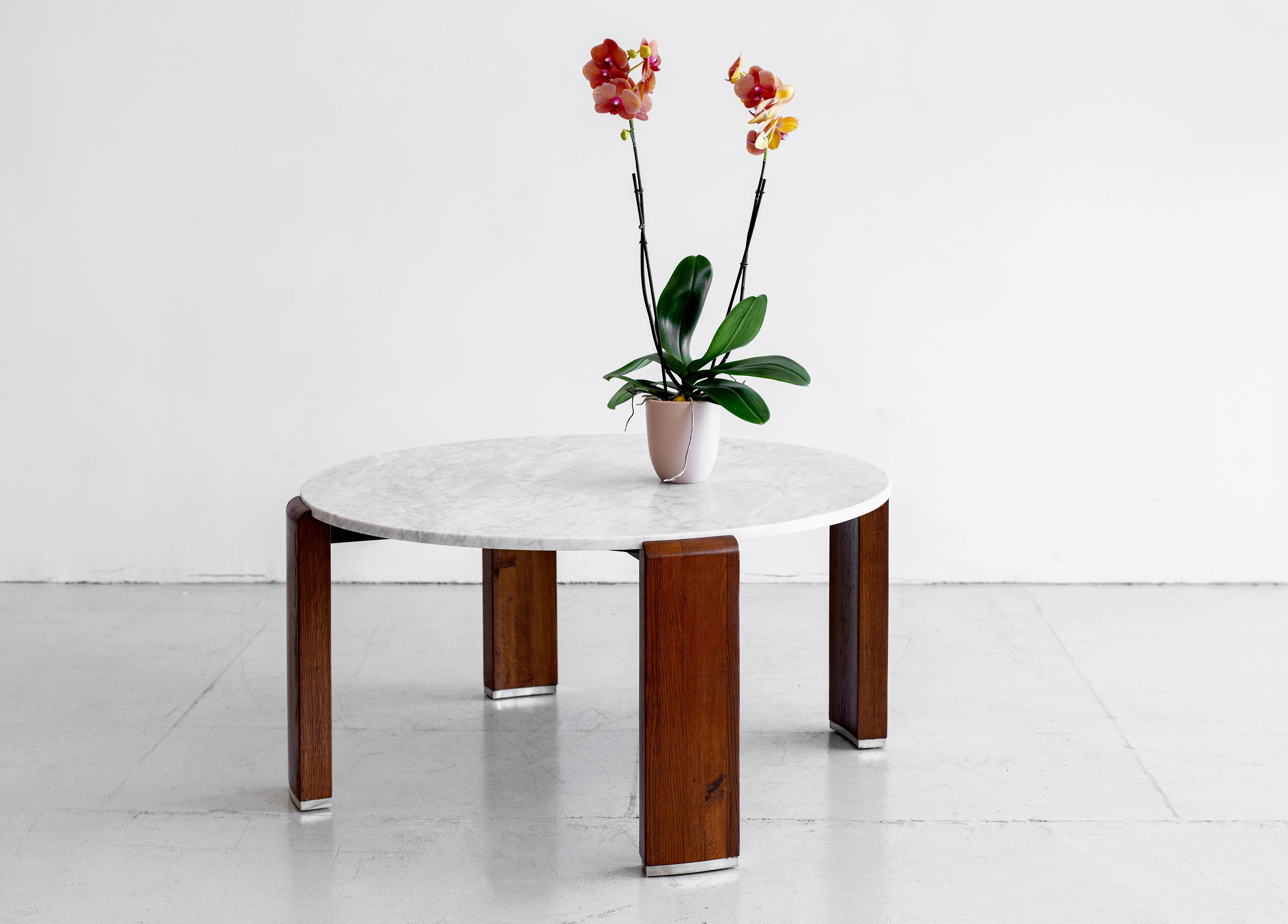 Beautiful high coffee table by French designer Louis Sognot. Circular rosewood base with metal detailing at fee. New Carrara marble top. Stunning Art Deco design.