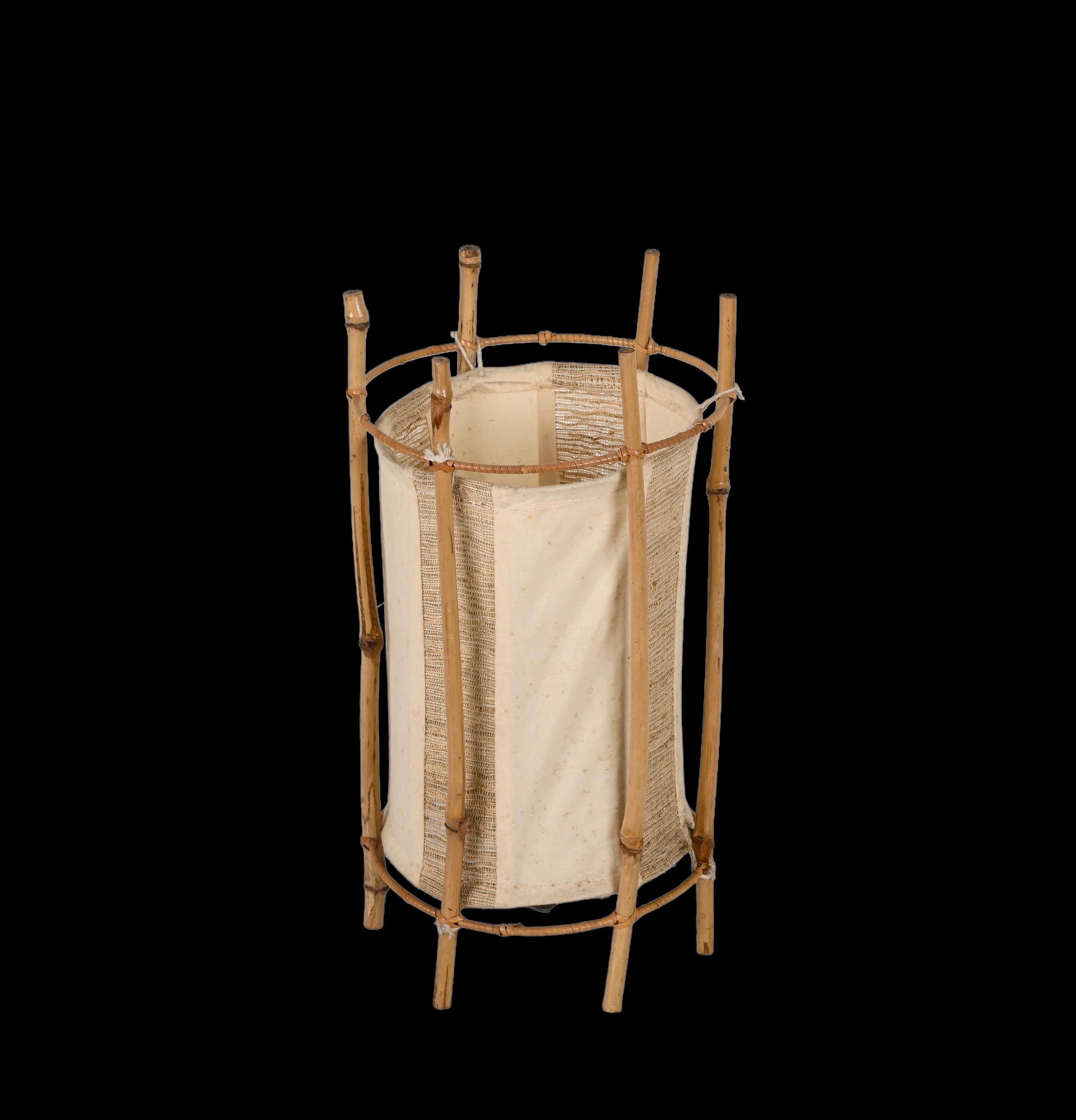 Wonderful mid-century table lamp in bamboo and rattan. This stunning lighting item was made in France in the 1960s in the style of Louis Sognot.

The outer structure is made up of six bamboo and rattan bamboo stems and contains a cylindrical shade