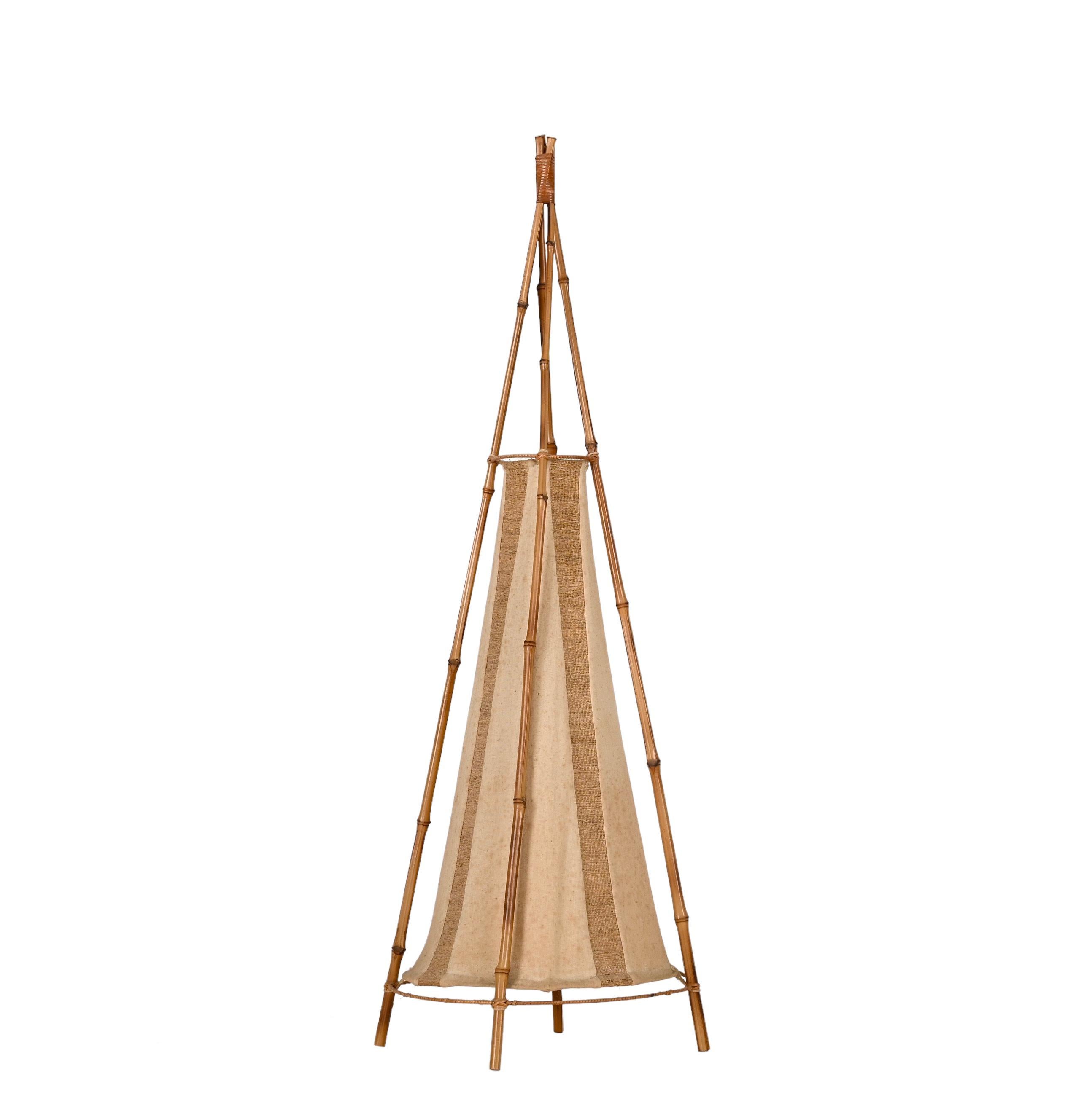 Stunning mid-century American Indian tent-shaped table or floor lamp in bamboo and rattan. This wonderful big lamp was made in Italy during the 1960s in the style of Louis Sognot.

The outer structure is made up of four bamboo and rattan bamboo