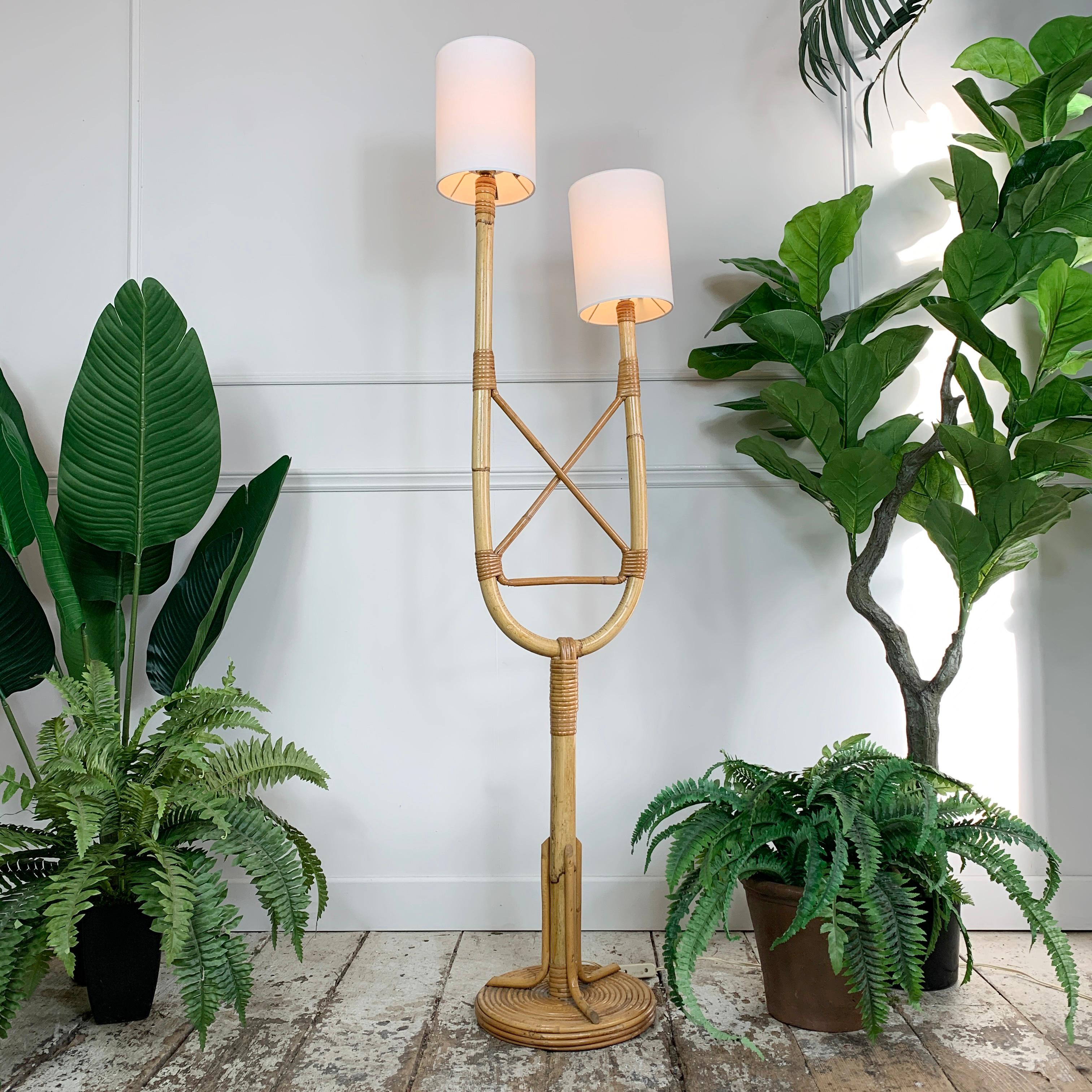 Natural rattan floor lamp by Louis Sognot
France 1950's
 
Hand crafted rattan, shaped and curved into a fabulous organic shape
Stylized twisted reed base
 
144cm height, 38cm width, 27cm width across base
Shades 20cm height x 15cm width

There are 2