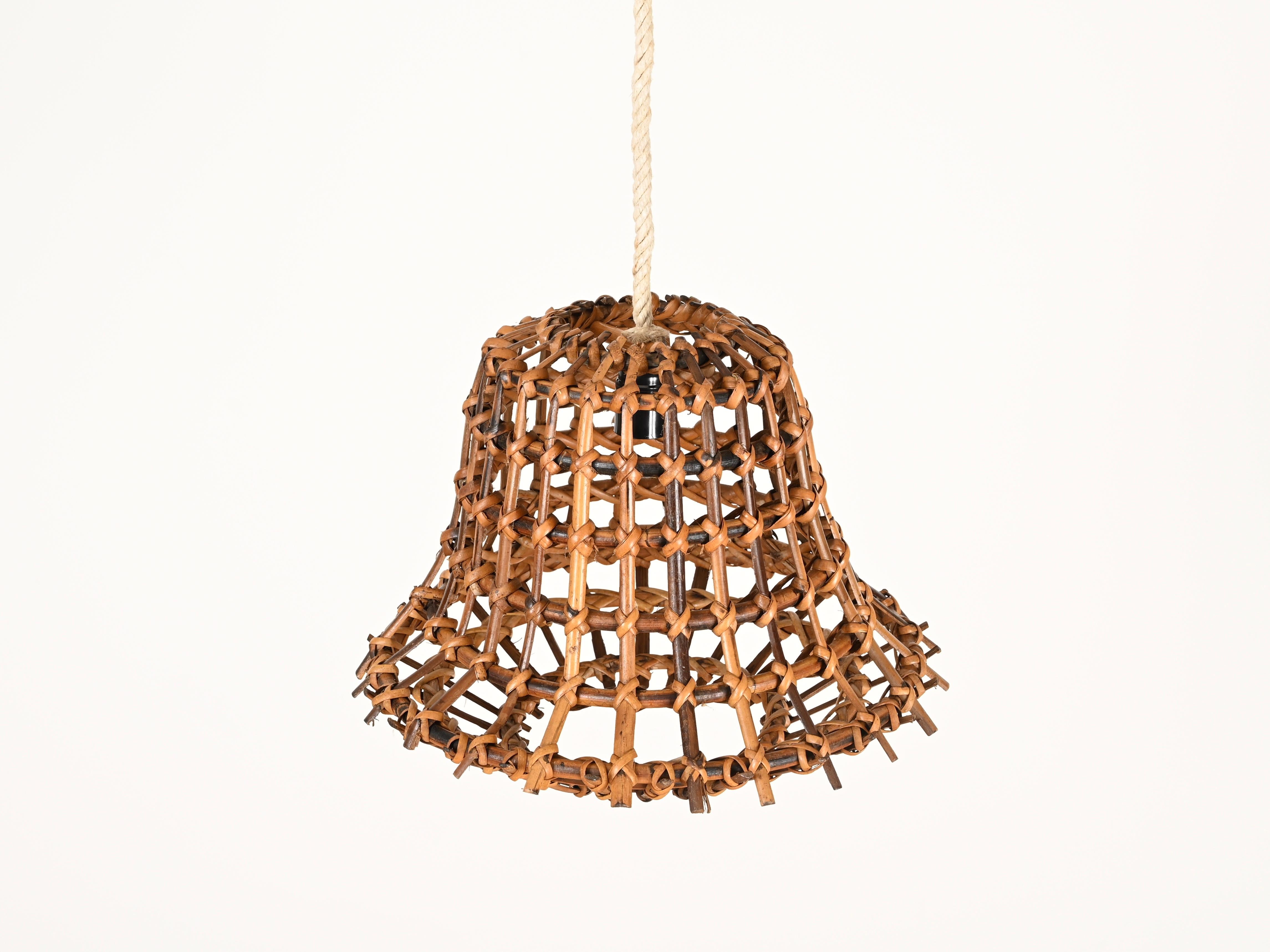 Stunning Mid-Century French Riviera–style pendant fully made of curved rattan and hand-woven wicker, completed with a rope cord. This incredibly charming piece is attributed to Louis Sognot and was produced in France during the 1960s.

In amazing