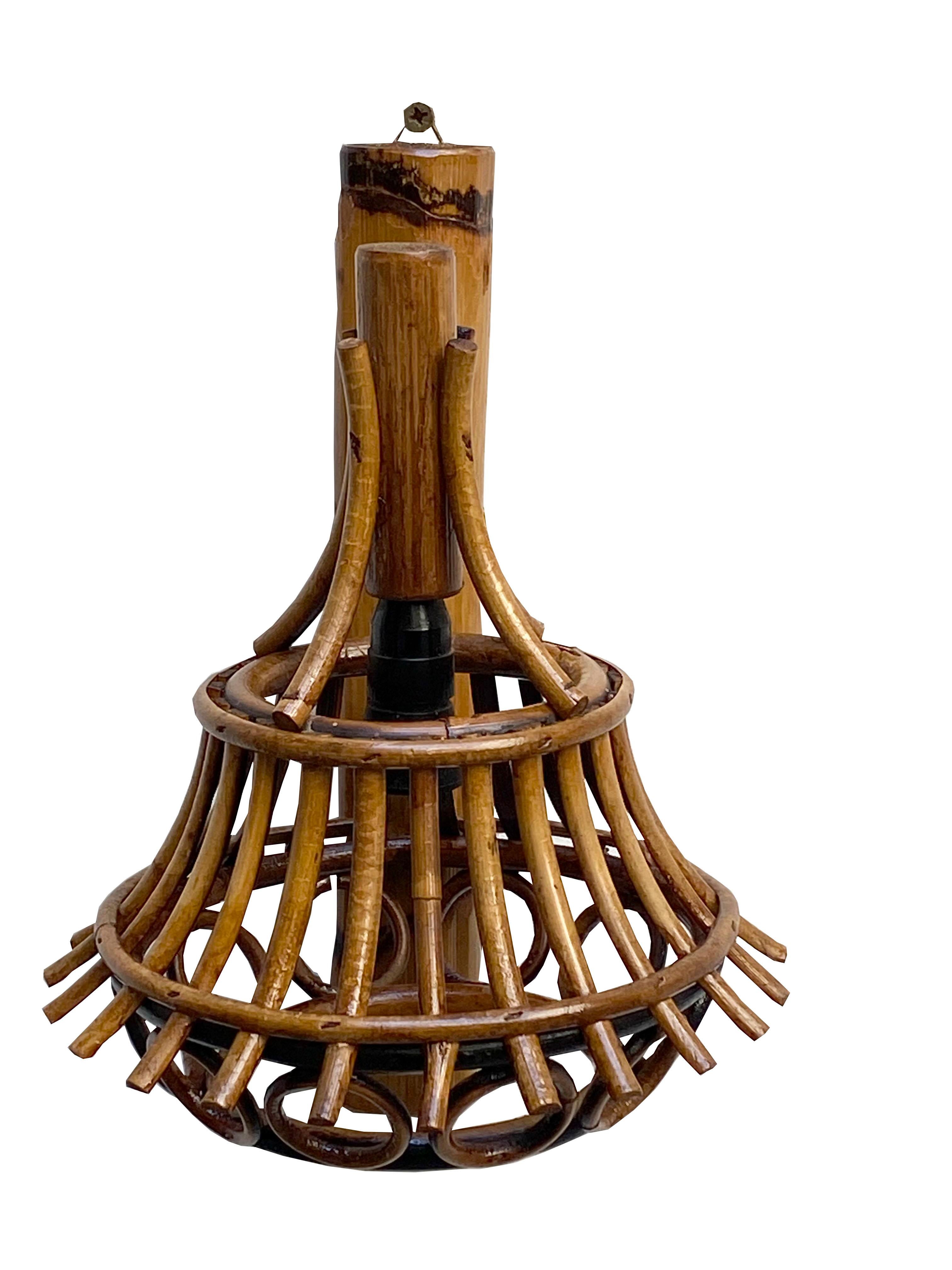 Wall lamp, consisting of a wall bracket and a central rattan stem supporting a suspended lampshade formed by a rattan cage.

 