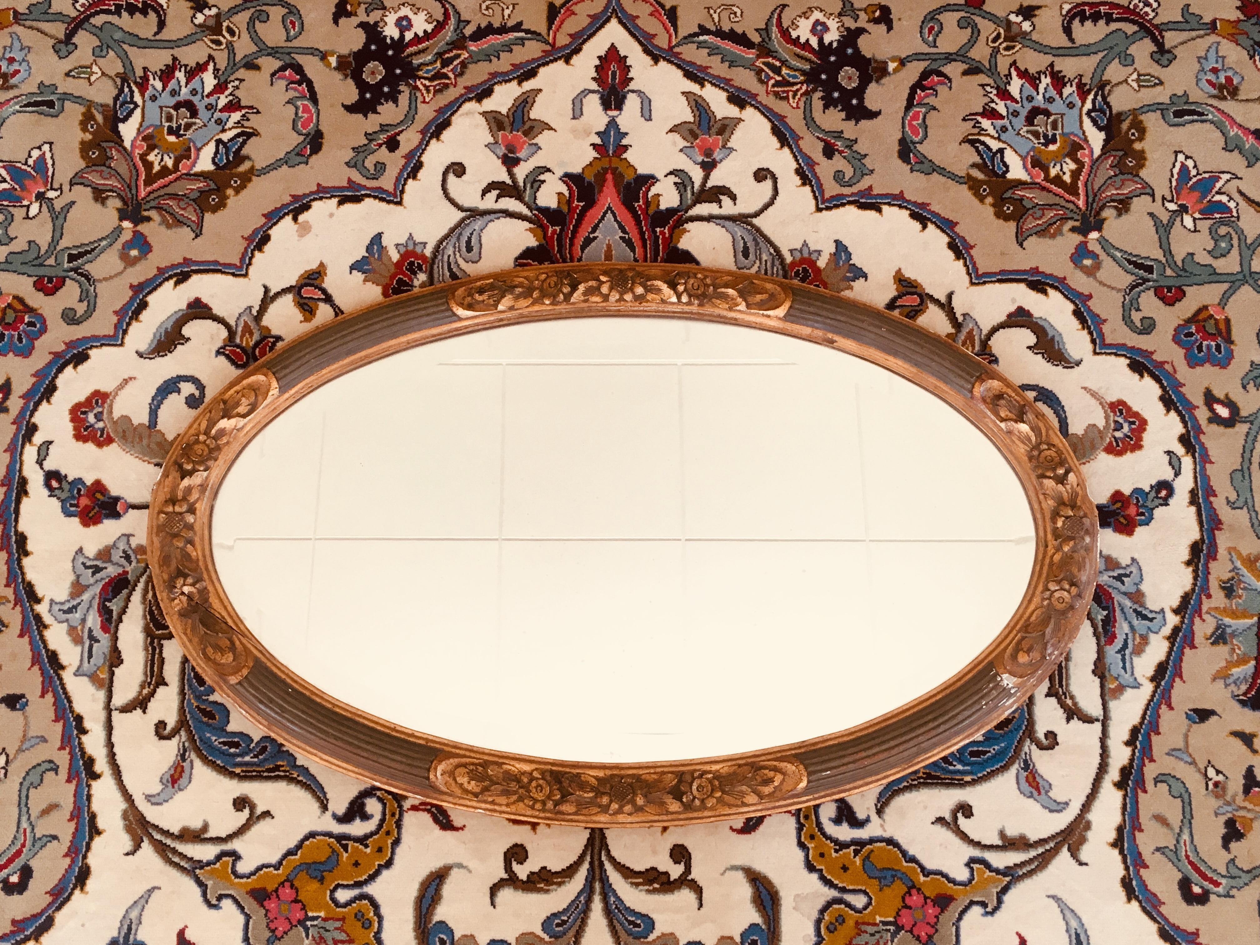 Large oval hand-painted giltwood mirror with original crystal glass by Louis SÜE and André MARE, France, circa 1920.