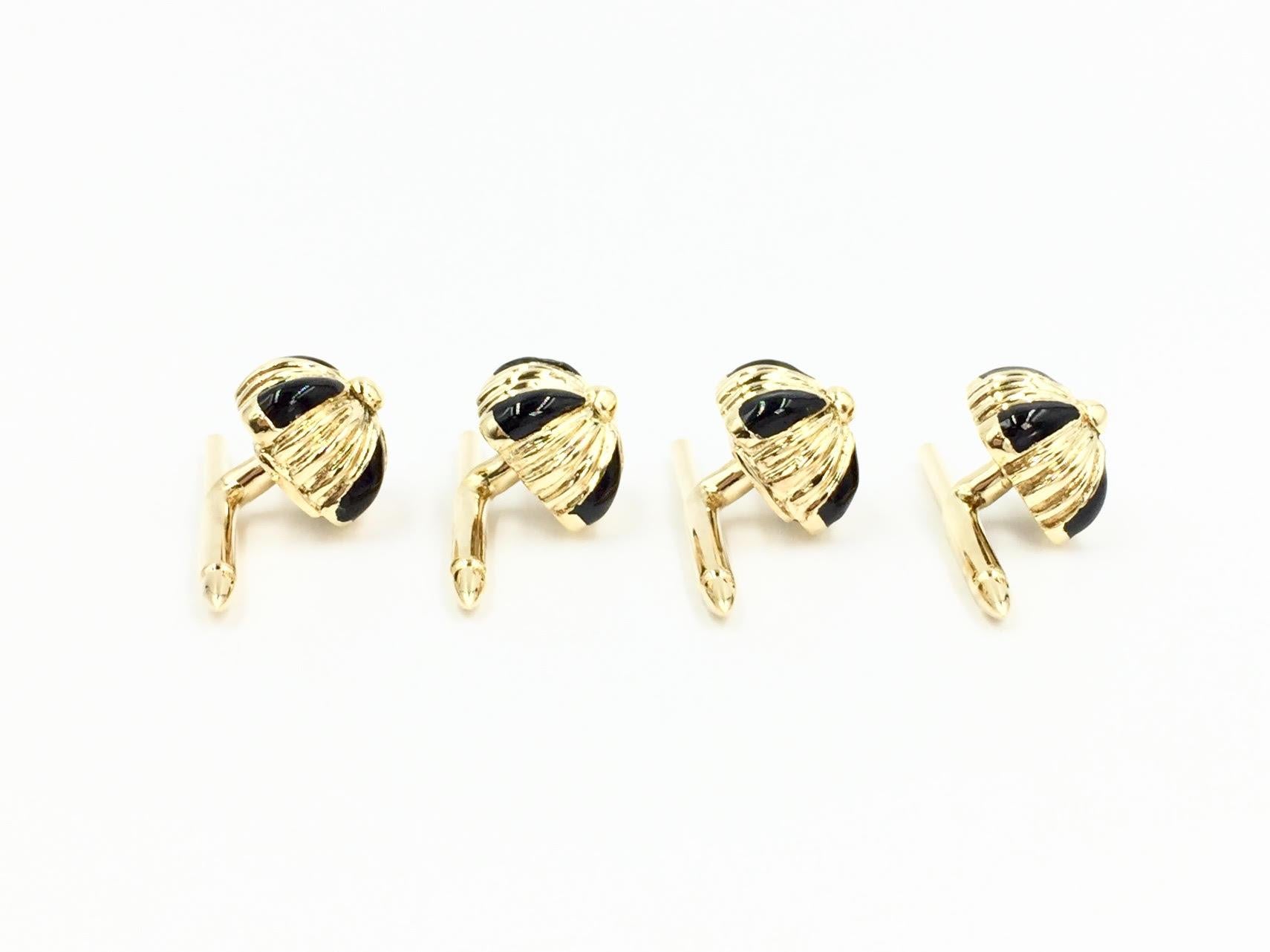 Made with impeccable craftsmanship by Louis Tamis & Sons Company. This set of four 18 karat yellow gold cushion shaped shirt studs have a fluted design with polished onyx at each corner. Cushion box measures 11mm x 11mm. Spring loaded bars work