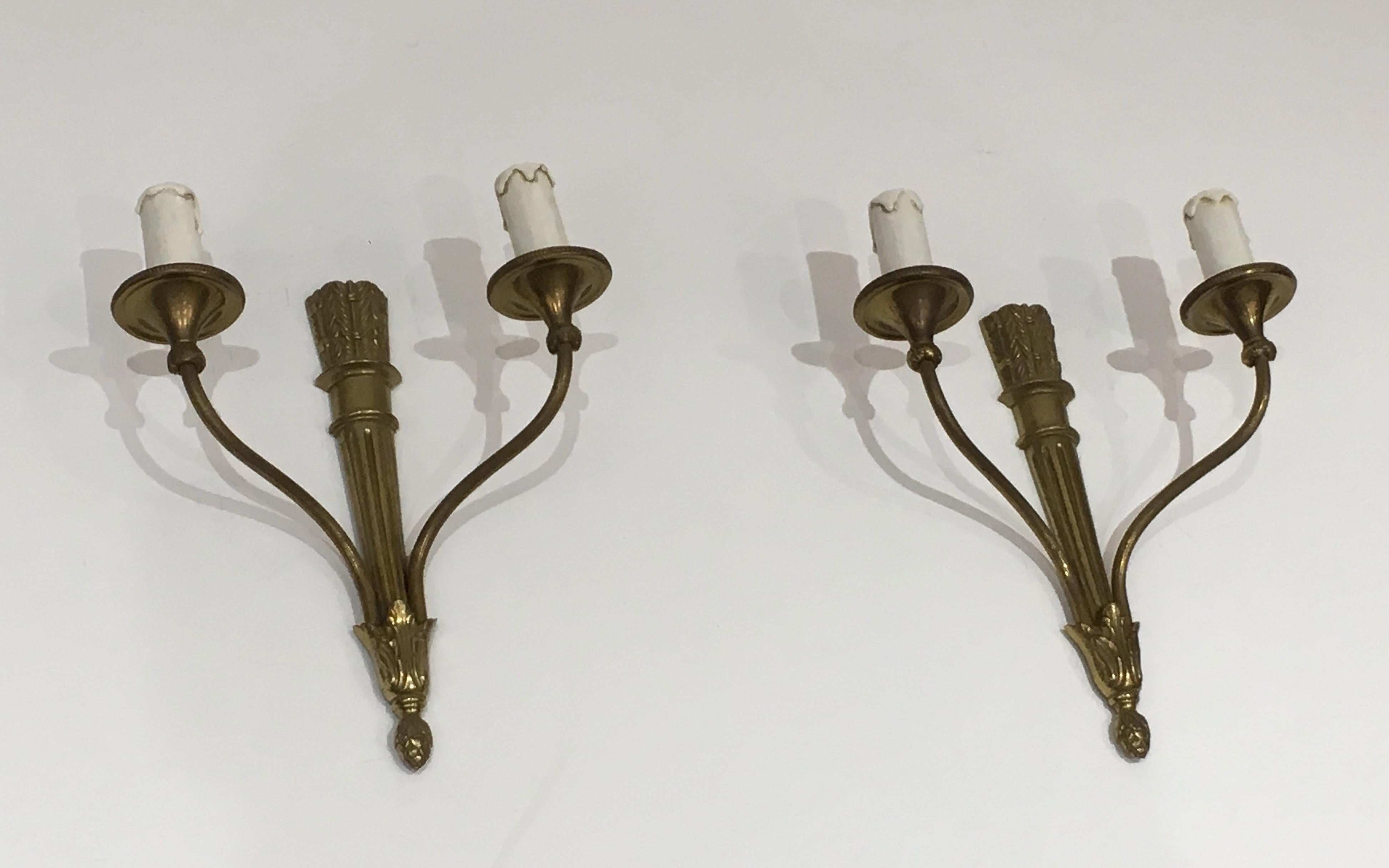 This pair of wall sconces is made of bronze. These sconces are in the style of Louis XVI with quivers. This is a French work, circa 1960.
