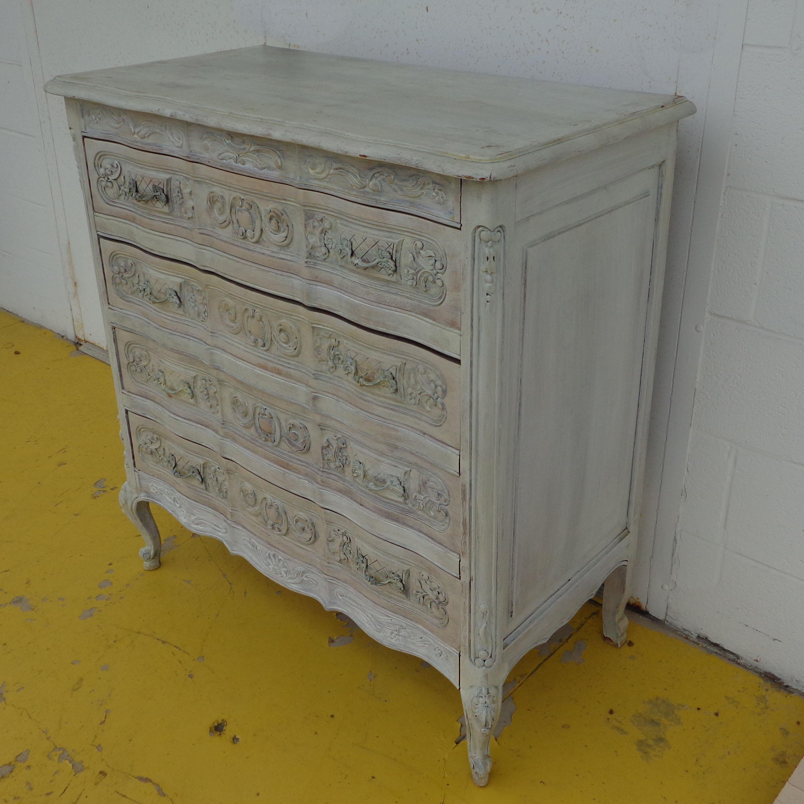 Louis the XV Style French Provincial painted dresser

Oyster wash with appliques of scrolls and floral motifs.
Four drawers. French cabriole legs.
  