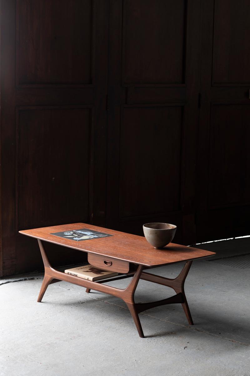 Coffee table designed by Louis Van Teeffelen and produced by Wébé in The Netherlands in the 1960s. The table is made of teak with a ceramic inlay produced by Dutch ceramist Jaap Ravelli. It features a magazine shelf underneath and a drawer that can