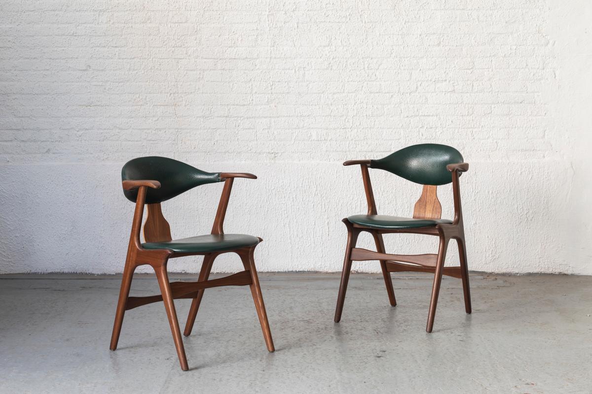 Set of 4 cowhorn dining chairs designed by Louis van Teeffelen and produced by Awa in the Netherlands in the 1950s. Teak frame and a British racing green skai upholstery. One of the backs has been restored neatly. The skai has a few small cuts as