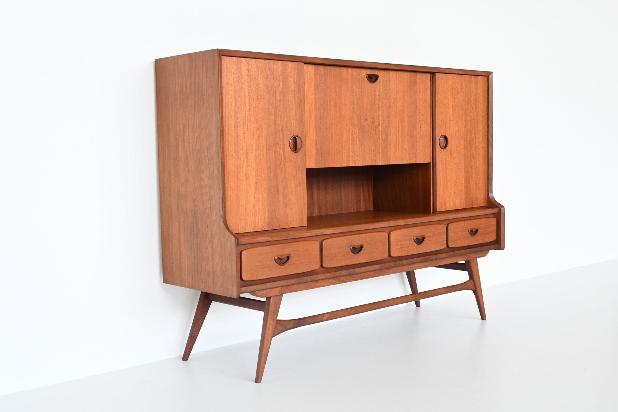 Beautiful symmetric highboard designed by Louis van Teeffelen and manufactured by Webe Meubelen, The Netherlands 1960. This very nice organic shaped cabinet is made of teak wood. Some very nice details are the well-crafted handles and beautiful