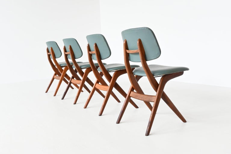 Very nicely shaped Scissor dining chairs designed by Louis van Teeffelen for Wébé, The Netherlands 1960. The chairs are made of solid teak wood and has turquoise faux leather upholstery. They seat very comfortable and give good support in the