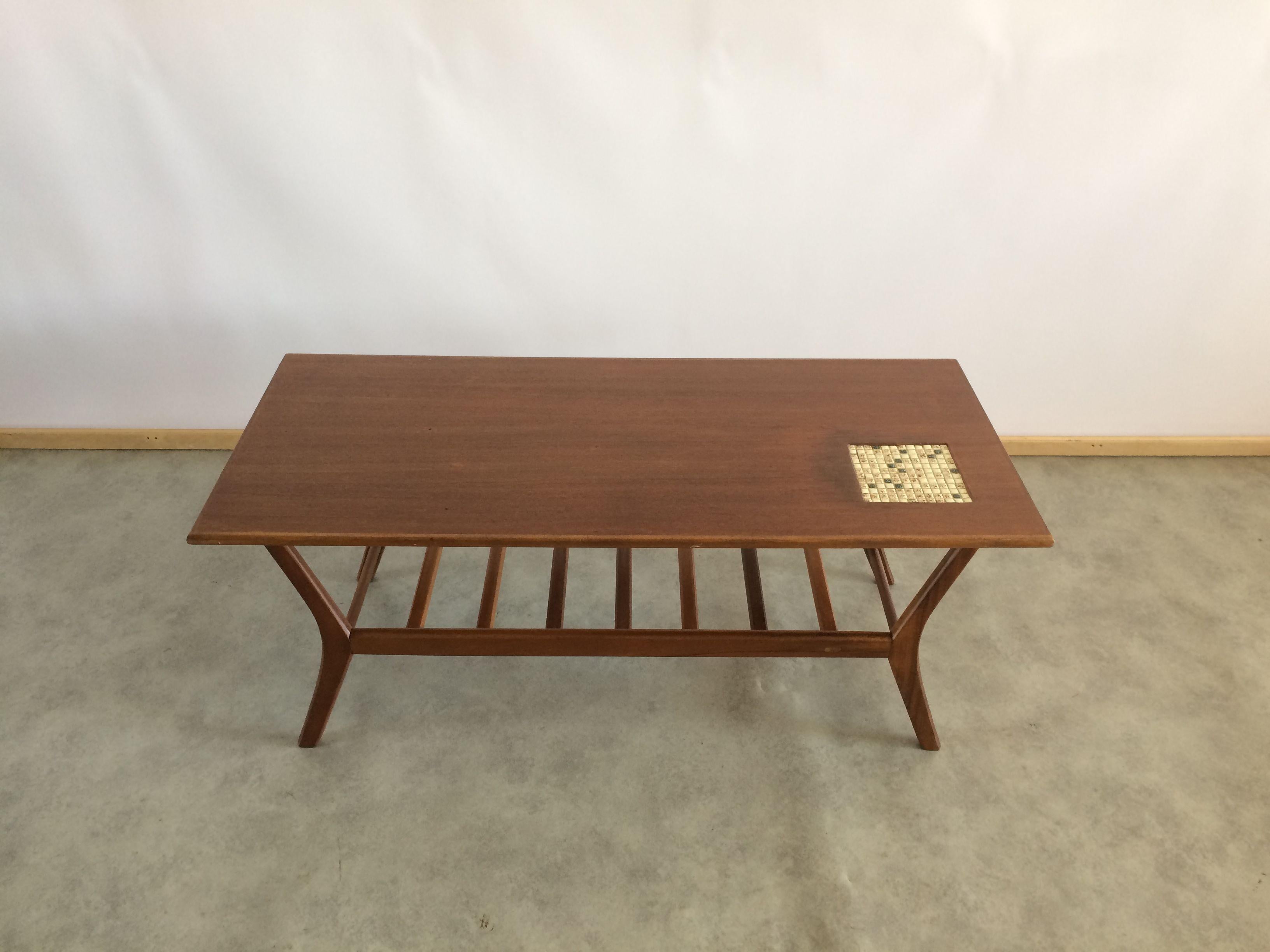 Teak coffee table by Louis Van Teeffelen for Wébé in 1960. Tray decorated with a mosaic. Magazine rack under the tray. Restored and in good condition. The furniture still has some nice patina which shows that it came from the 60's.