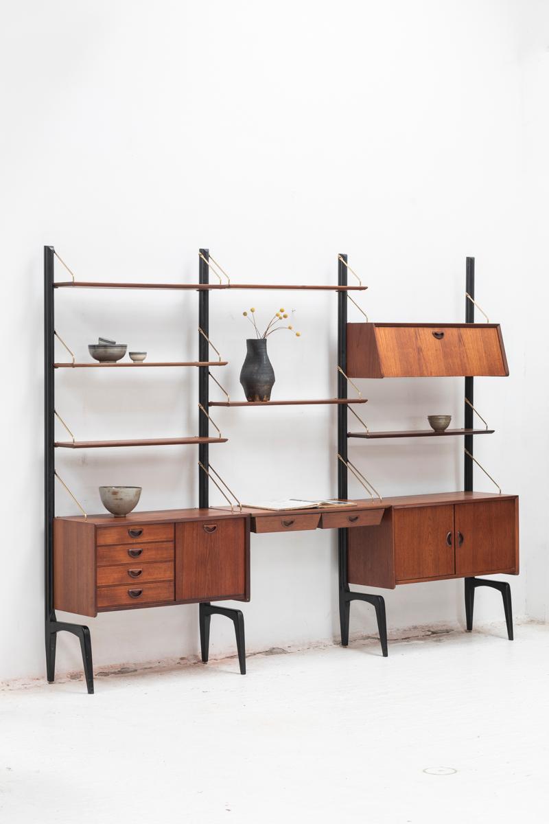 3-piece wall unit by Louis van Teeffelen for Wébé, Dutch design 1960’s. This set features four organic uprights in black lacquered wood and a variety of shelves and cabinets. This is a modular wall unit, all elements can we arranged as desired. In
