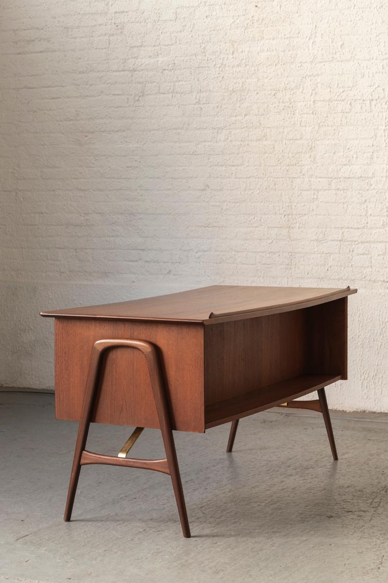Writing desk, designed by Louis Van Teeffelen and produced by Wébé in Holland in the 1960s. This desk features 3 drawers, a pull out leaf and a drop-front storage cabinet. Can be used as a freestanding desk with a neat bookshelf on the frontside.