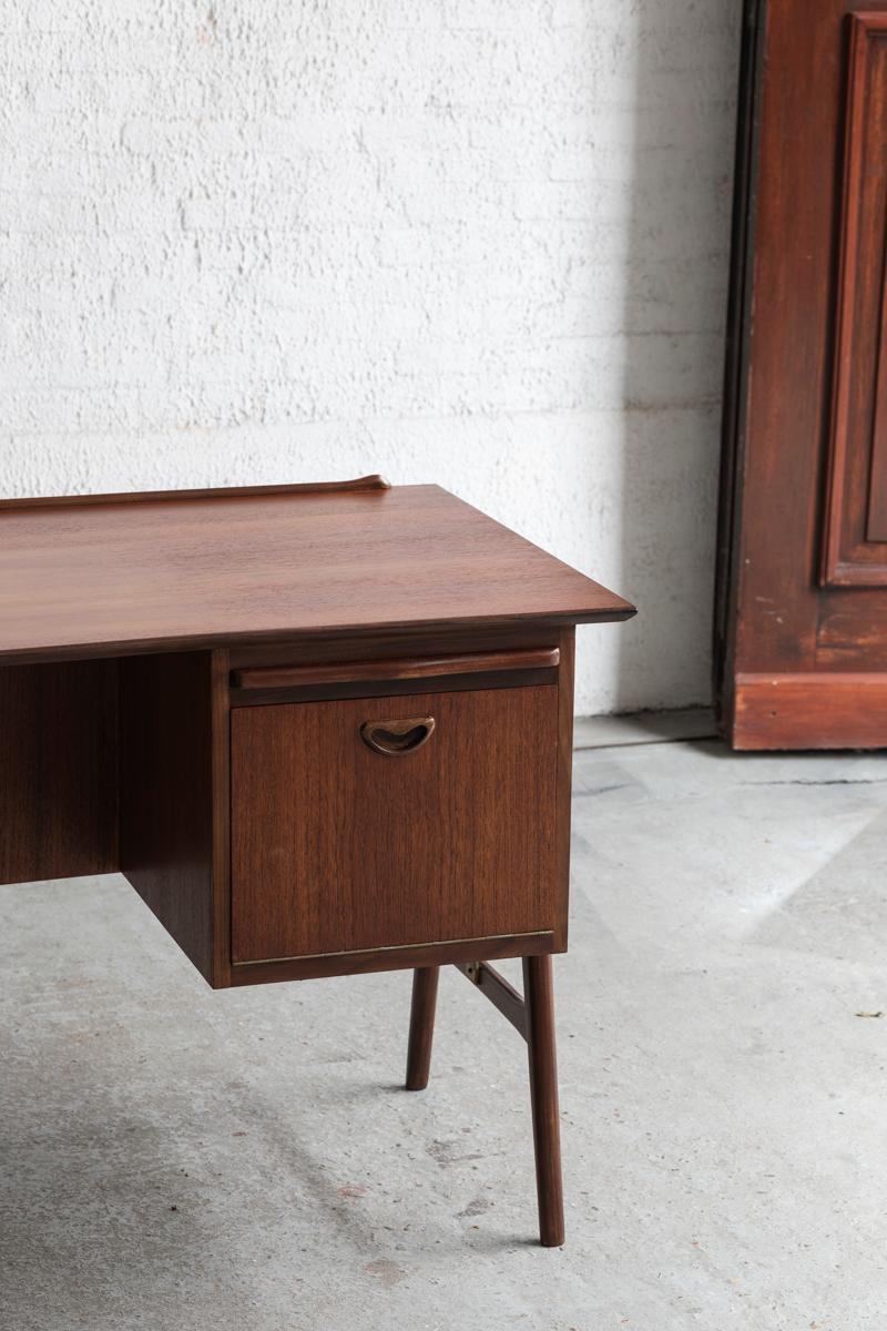 Writing desk designed by Louis van Teeffelen and produced by Wébé in the Netherlands around 1960. This desk features a teak veneer table top with 3 drawers on the left, a cabinet on the right hand side and a bookshelf on the back. It can be used