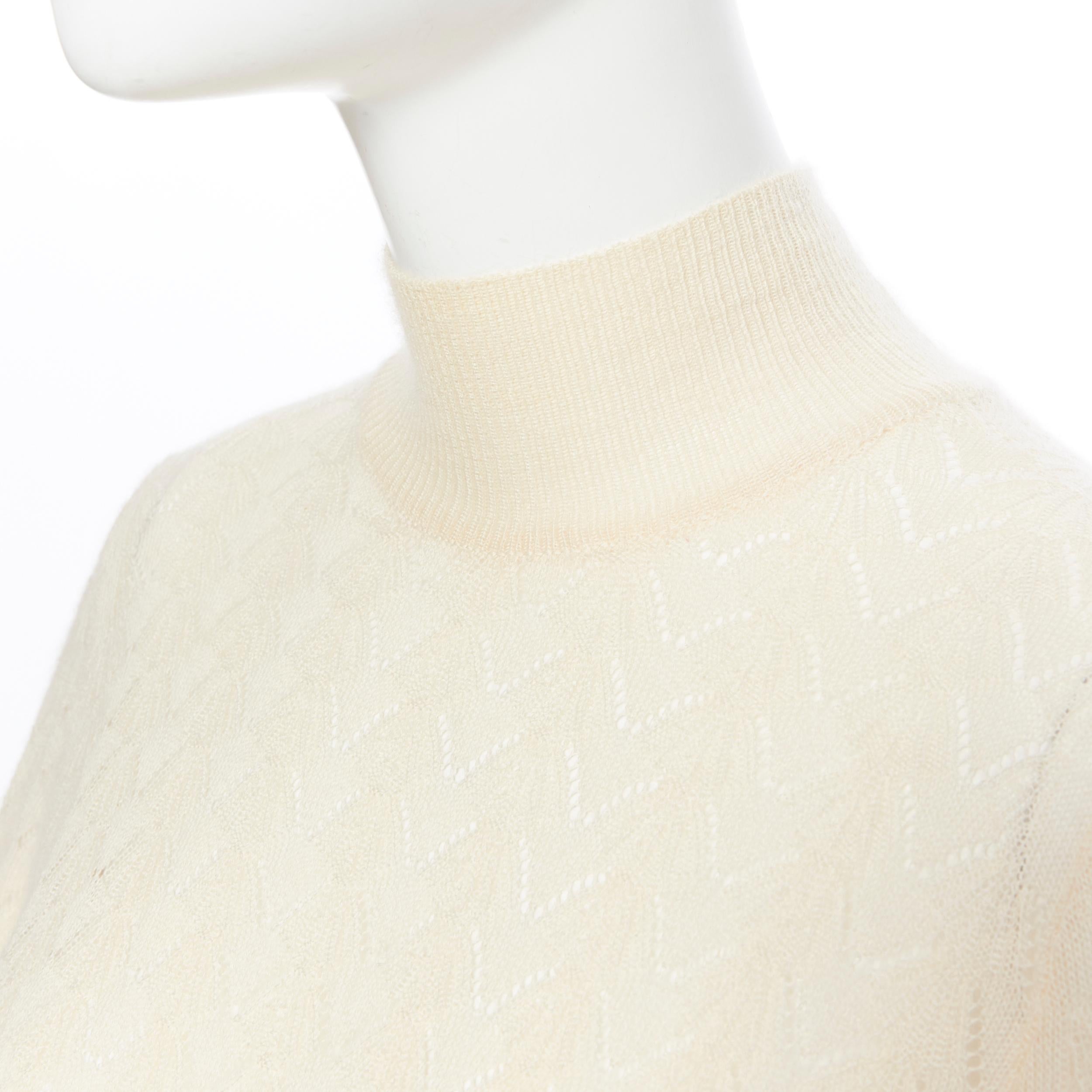 LOUIS VUITTON 100% cashmere cream beige lace knit  turtleneck sweater top M
Brand: Louis Vuitton
Model Name / Style: Cashmere turtleneck
Material: Cashmere
Color: Beige
Pattern: Geometric
Extra Detail: Long sleeve. Turtleneck neckline.
Made in: