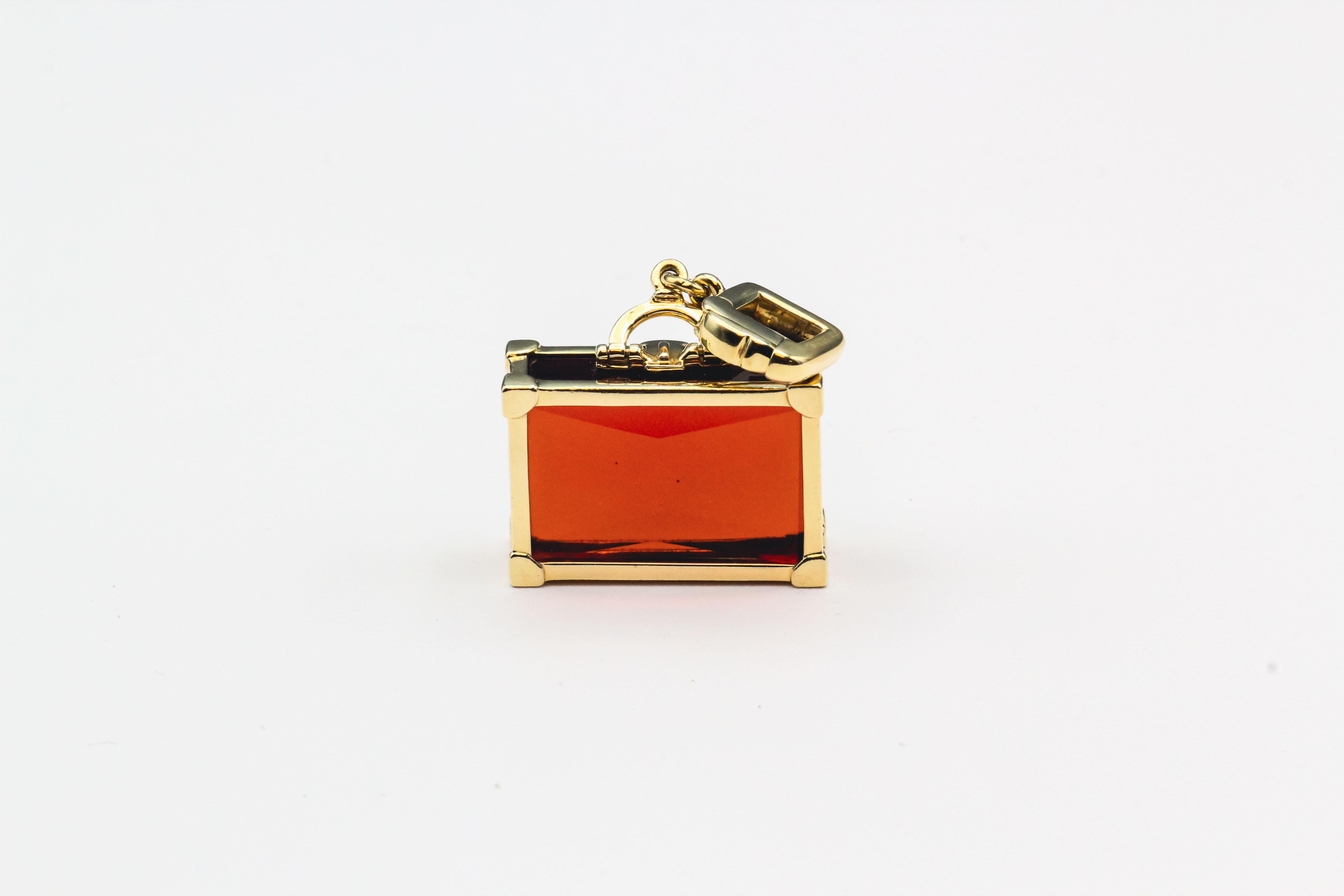 Embark on a journey of luxury and style with the Contemporary Louis Vuitton Citrine and 18k Yellow Gold Suitcase Charm Pendant. This exquisite piece seamlessly blends modern elegance with the timeless allure of travel, showcasing Louis Vuitton's