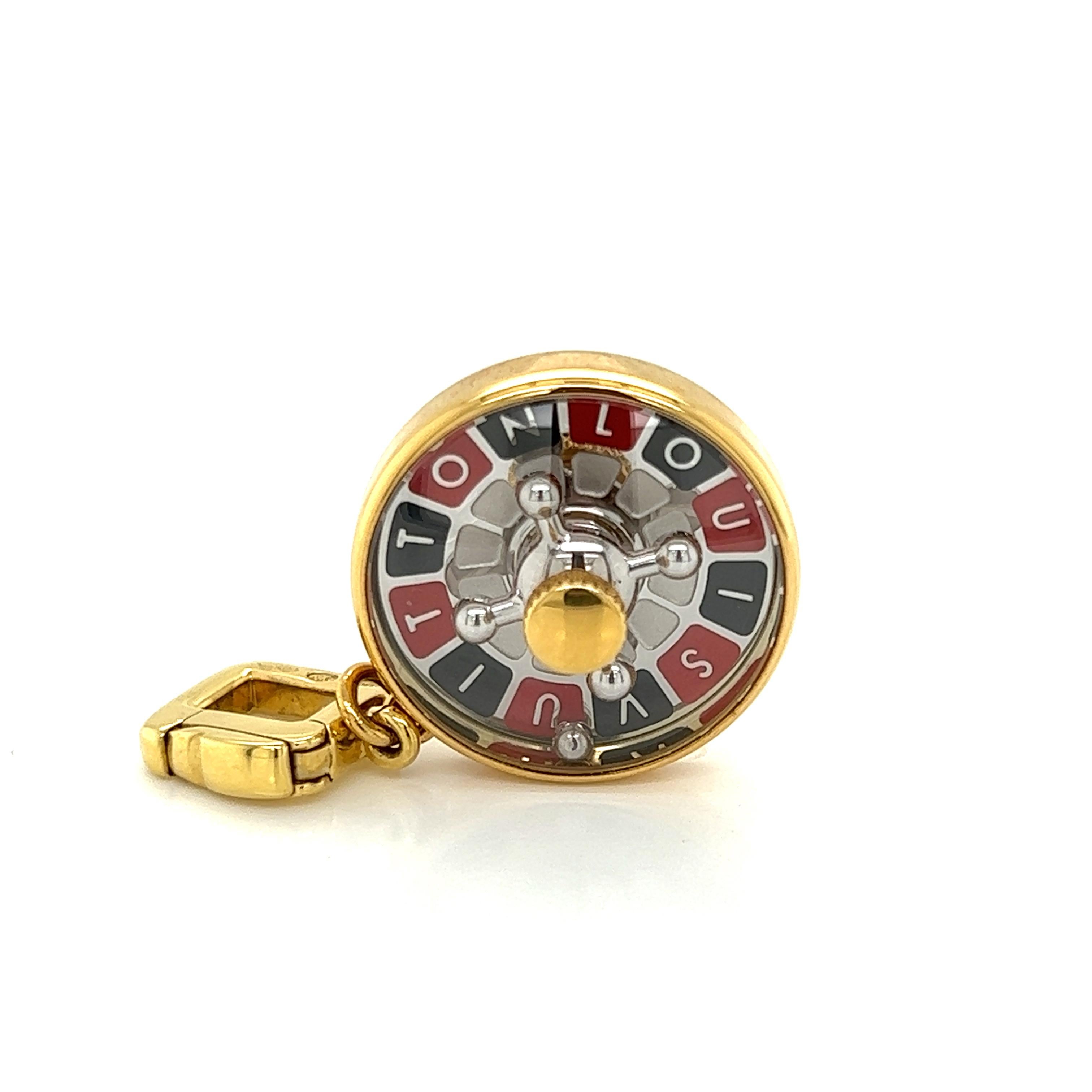 This is a charming authentic pendant or charm from Louis Vuitton. It is crafted from 18k yellow gold featuring a high dome sapphire crystal cover over a roulette game wheel set in a round gold frame with solid gold back engraved in script GOOD LUCK.