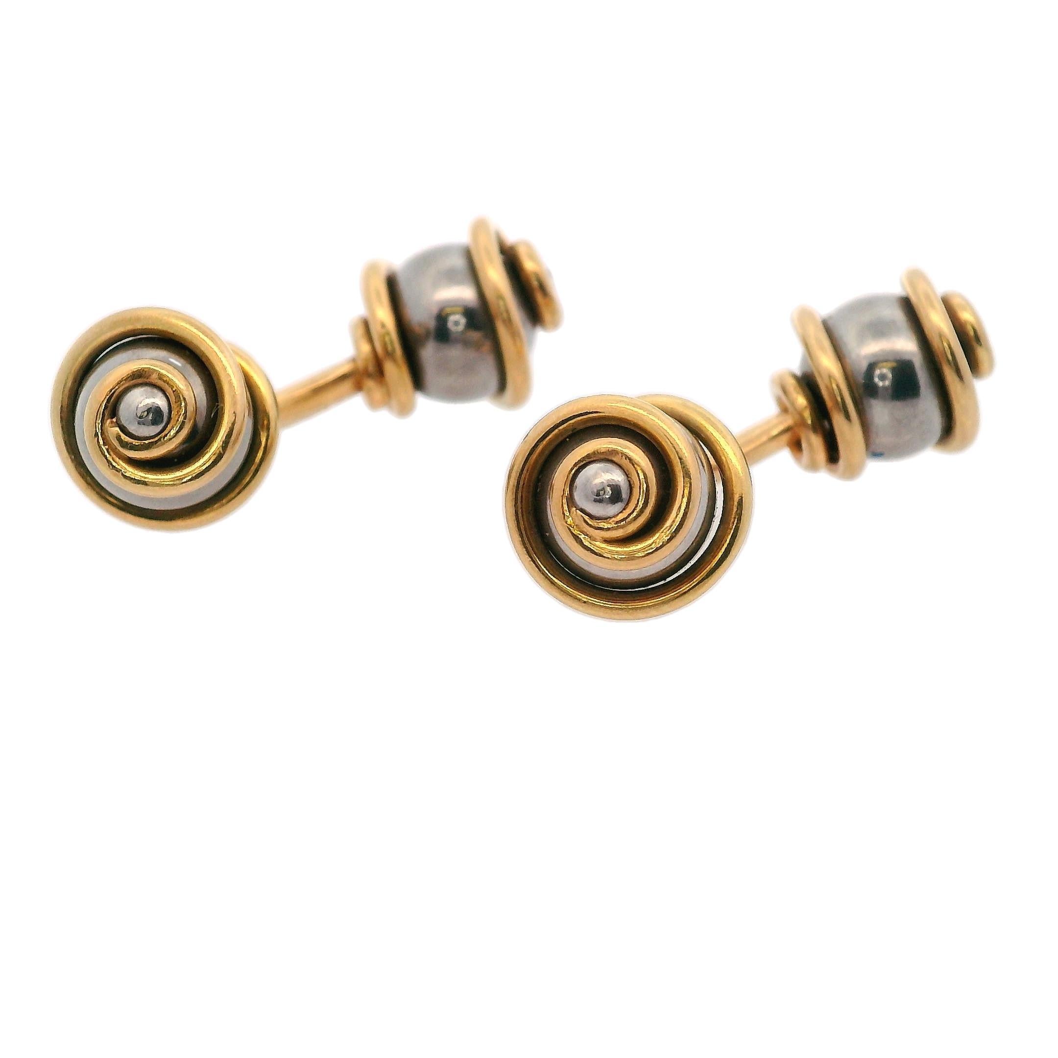 Introducing a pair of elegant cufflinks expertly crafted by Louis Vuitton, blending the luxurious appeal of 18k yellow gold with the modern durability of stainless steel. These cufflinks exude sophistication and style, making them the perfect