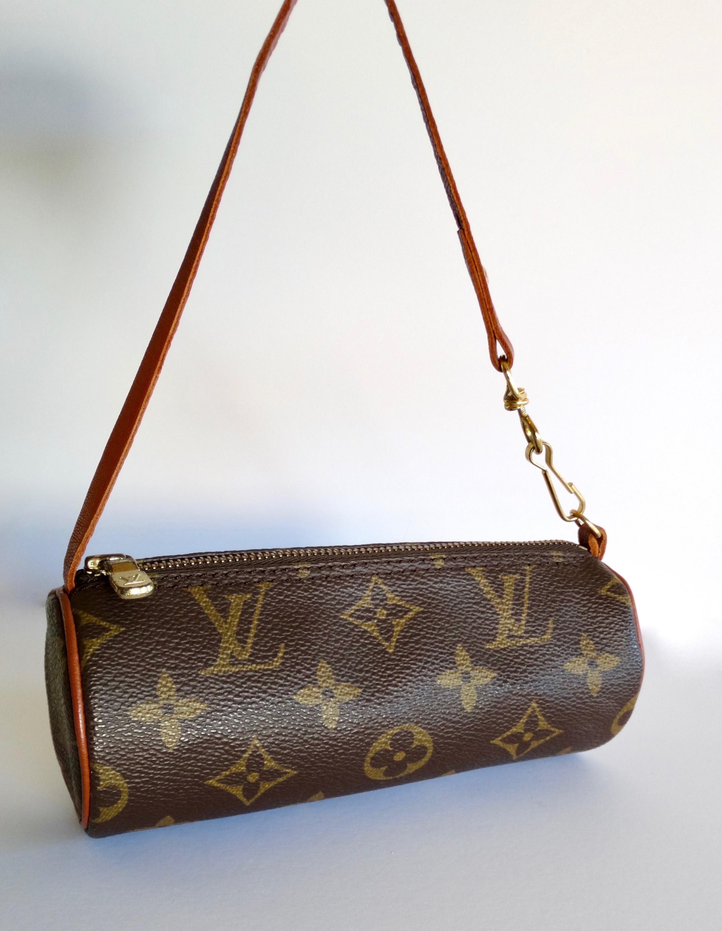 Complete or start your Louis Vuitton collection with this adorable bag! Originally designed in 1966, this mini pochette is circa 1990s and is the smaller version of the popular Papillon handbag. Crafted from Louis Vuitton's signature monogram