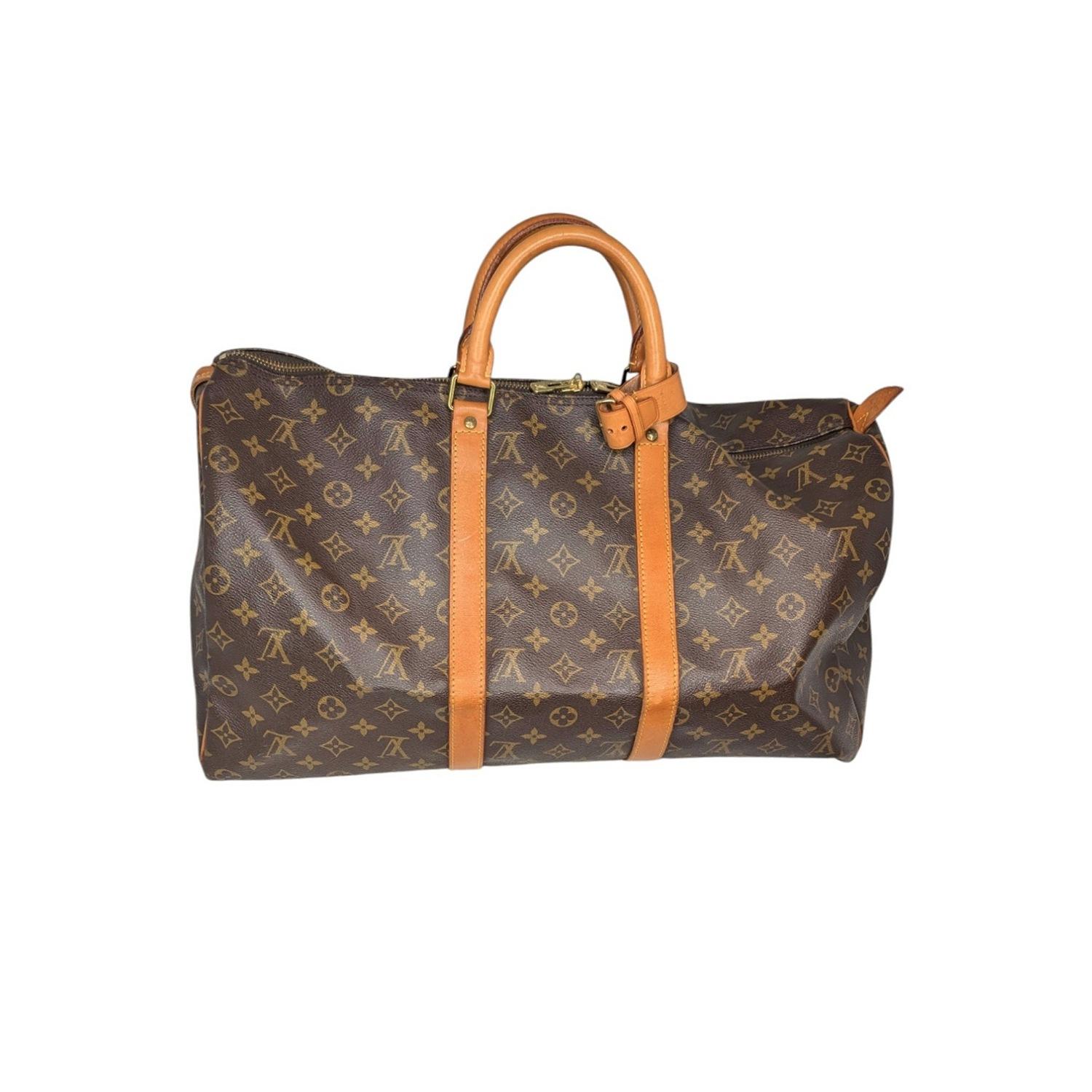 From the 1993 Collection; Louis Vuitton Keepall 50 Duffel Bag in brown coated canvas with the iconic LV logo monogram pattern and brass hardware. It features dual rolled handles, canvas lining and a zip closure at top. Comes with an Entrupy