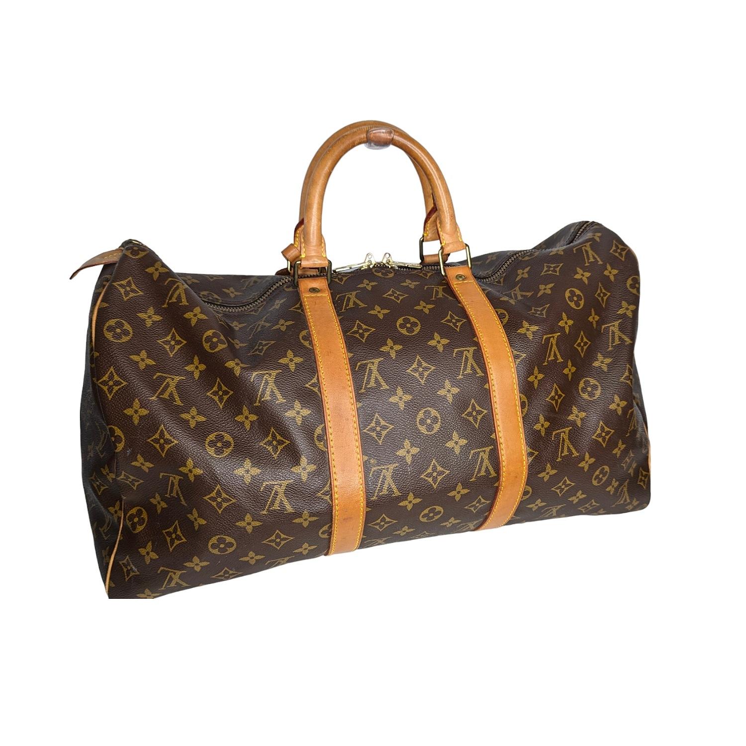 The perfect carry-on Keepall duffle bag rendered in the house's iconic Monogram coated canvas, featuring Vachetta leather trim and accented with gold-tone brass hardware. Est. Retail $1,740.

Designer: Louis Vuitton
Material: Monogram canvas;