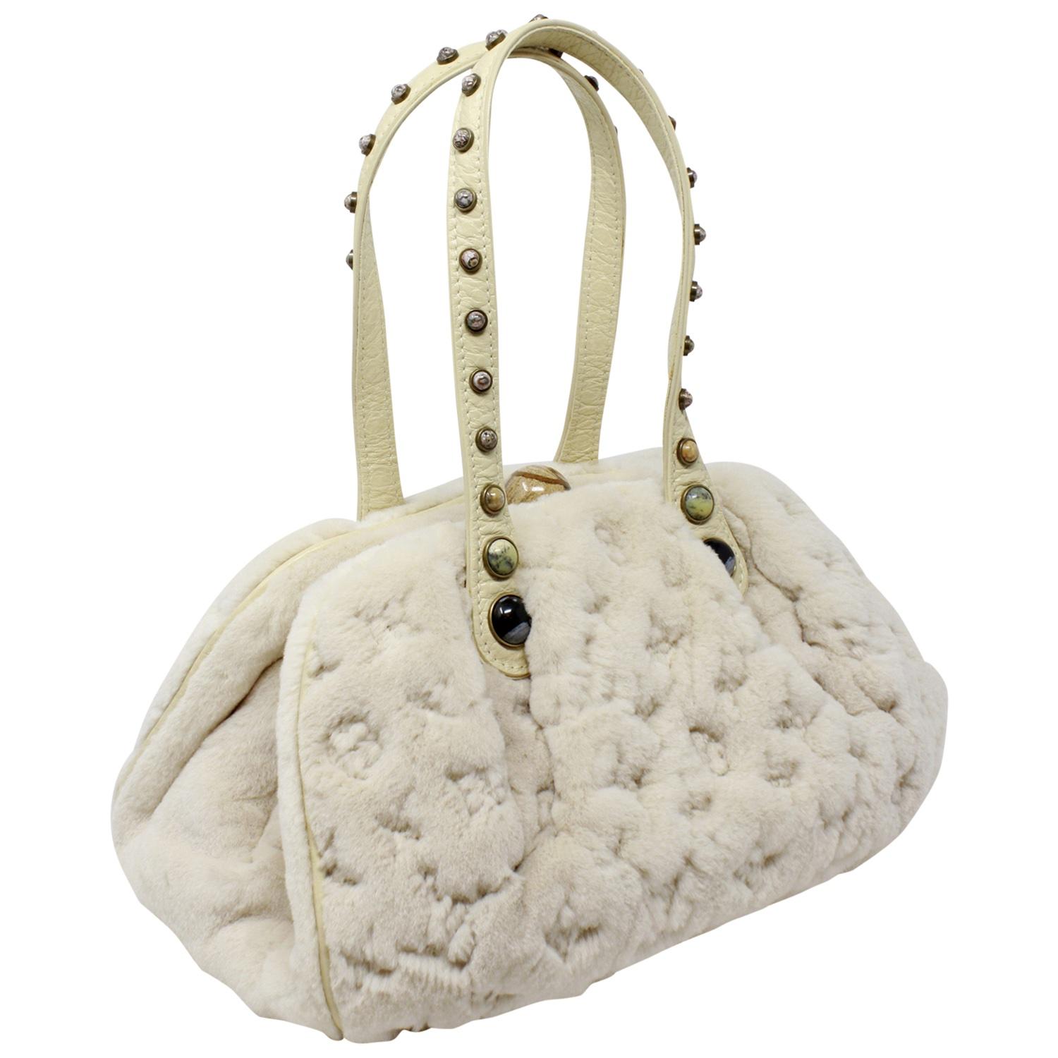This iconic and rare beauty graced the runway in the 2005 Louis Vuitton FallWinter Collection and was created by creative director Marc Jacobs. It is so special and unique that it completely leaves us speechless! Crafted in cream mink and tonal