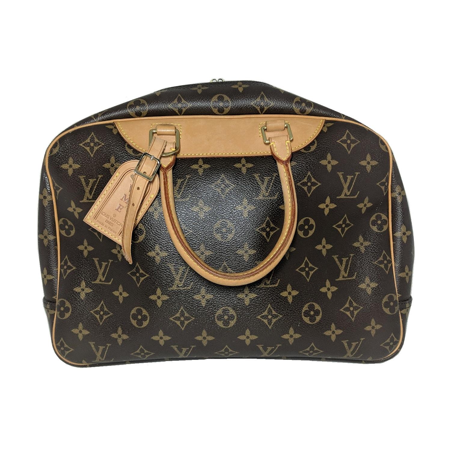 This Louis Vuitton Monogram Deaville Canvas Bowling bag, is crafted from brown and tan monogram coated canvas, features dual rolled top handles, cowhide leather trim, and brass hardware. Its two-way zip-around closure opens to a beige canvas lining