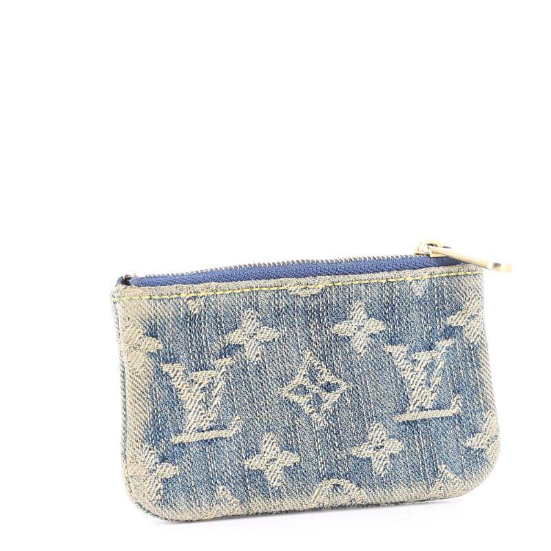 Louis Vuitton Denim Monogram Coin Pouch 2007

Good condition, shows some signs of use on the outside edges
Denim cotton body with orange lambskin leather lining. zip fastening and chain hook for keyrrings.
Packaging:  Opulence Vintage dust