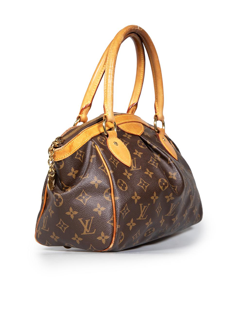 CONDITION is Very good. Minimal wear to bag is evident. The handles are discoloured and have abrasions. The leather boarder has water marks and abrasions. The piping along the corners is discoloured and is exposing interior structure. The feet are