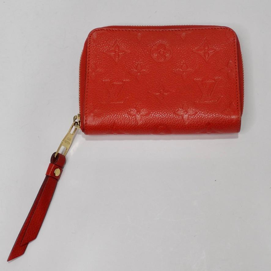 Do not miss out on this tiny piece of fashion history! Stunning red leather wallet from Marc Jacobs's 2012 collection for Louis Vuitton. Gorgeous cherry red empreinte is contrasted with a subtle signature Louis Vuitton monogram and completed by