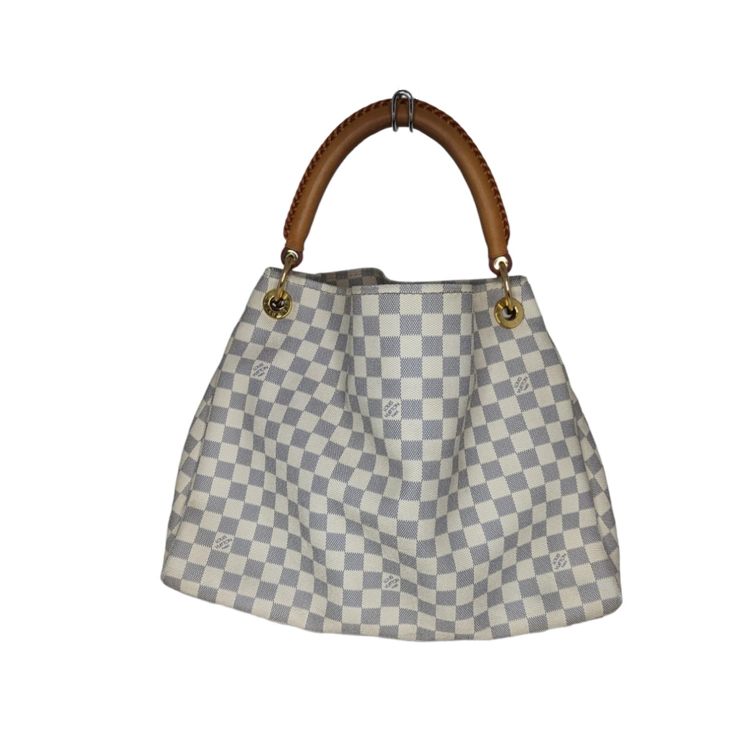 The Artsy MM looks fresh and feminine in supple Damier Azur canvas. Adorned with shiny golden brass and a chic bag charm, its exquisite handcrafted leather handle adds a luxurious crowning touch. Retail $2,500.

Designer: Louis Vuitton
Material:
