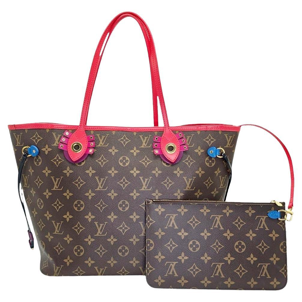 From the Fall/Winter 2015 Collection; Louis Vuitton Totem Neverfull MM Bag in the iconic Monogram Canvas with colorful smooth leather trimmings. With engraved metal accents inspired by Gaston Vuitton's African tribal masks collection.  The bag