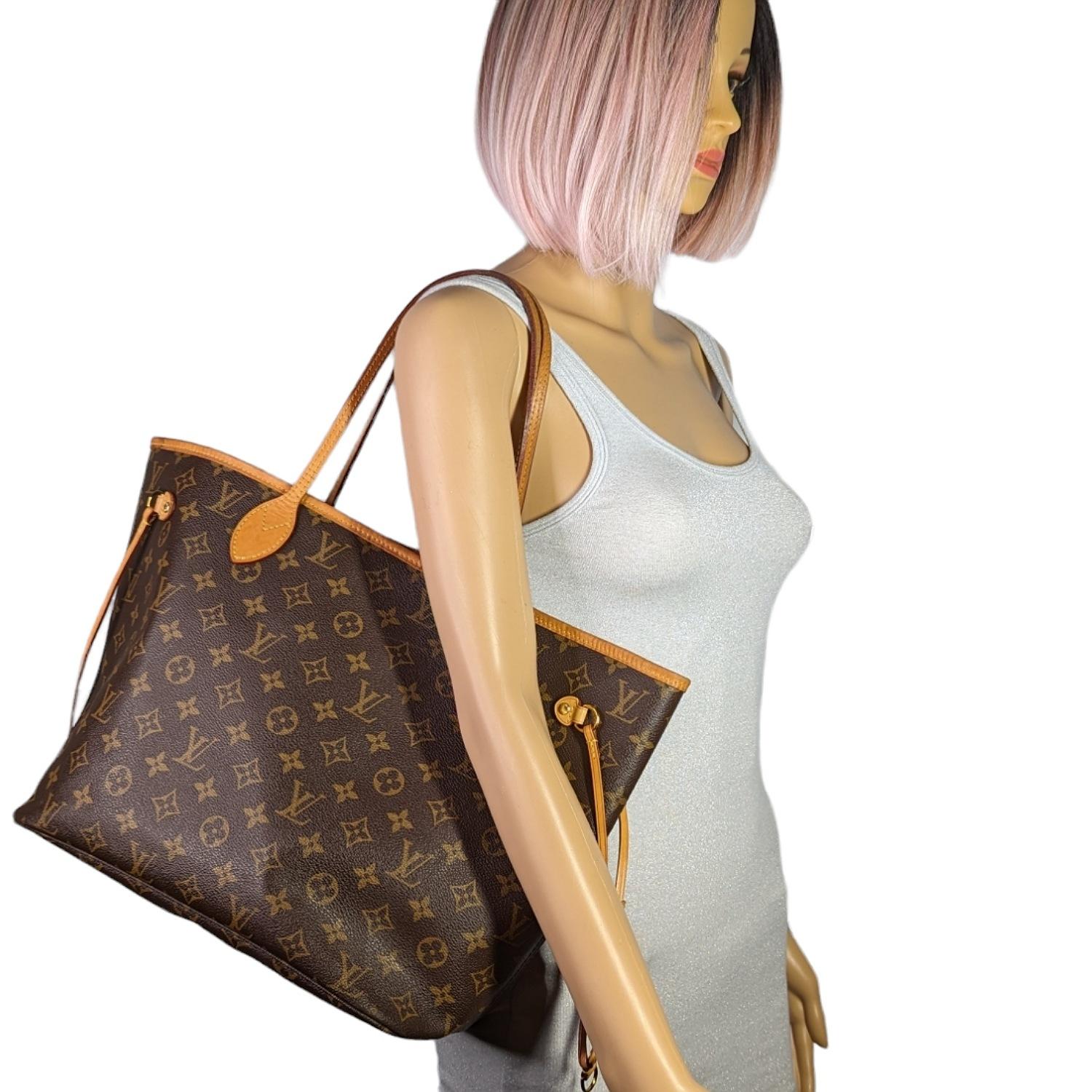 This stylish tote is crafted of classic Louis Vuitton monogram on coated canvas. It features vachetta cowhide leather trim, shoulder straps, and side cinch cords. The top is open to a fabric interior with a hanging zipper pocket. Retail price