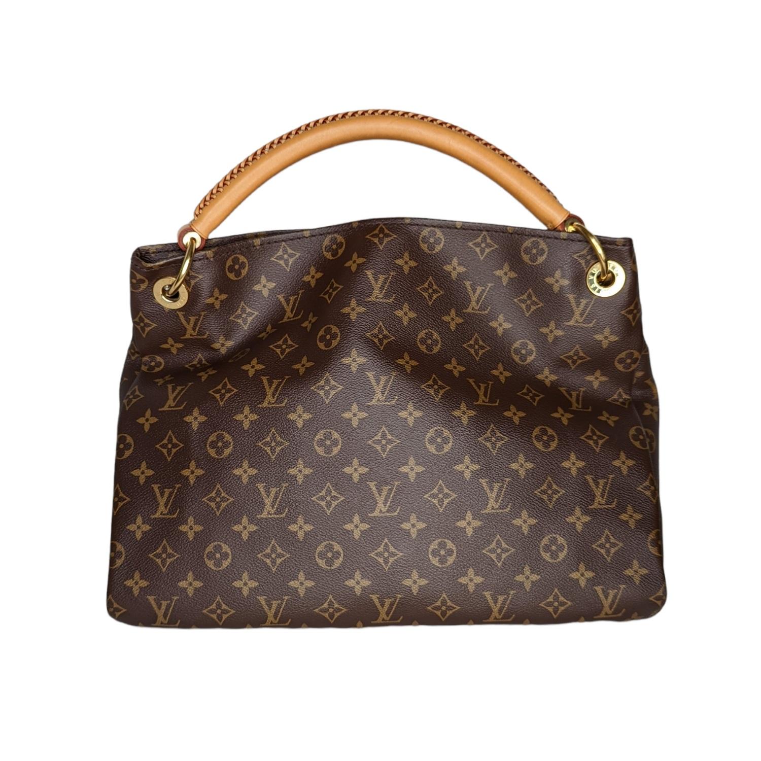 The Louis Vuitton Monogram Canvas Artsy MM Bag has a unique and modern structure. This roomy tote makes a perfect work or weekend bag, large enough to hold all your essentials in style. It features a detachable stylish Louis Vuitton key ring for