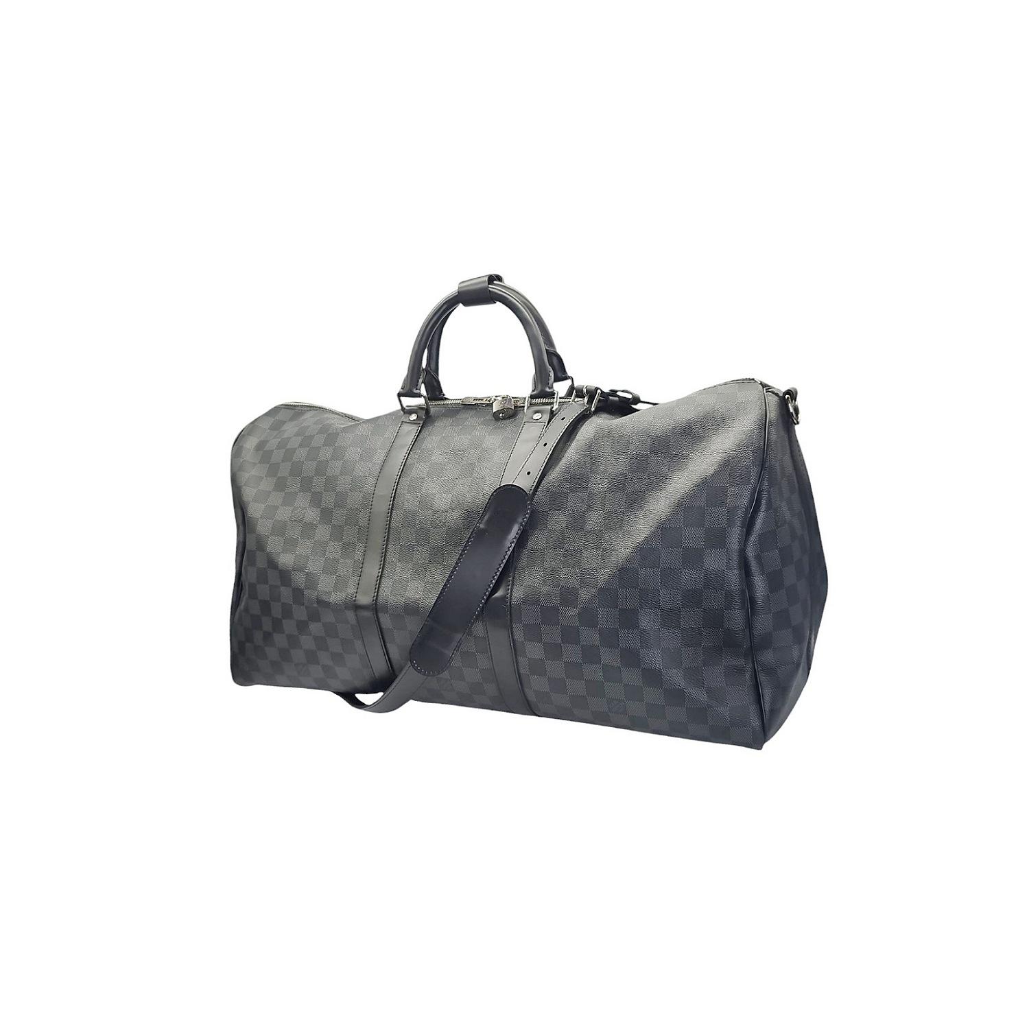 Indulge in luxury travel with the Louis Vuitton Damier Graphite Keepall Bandouliere 55. Crafted of iconic Damier check canvas and dyed cowhide trim, this travel bag exudes sophistication. Featuring sturdy leather top handles and an adjustable