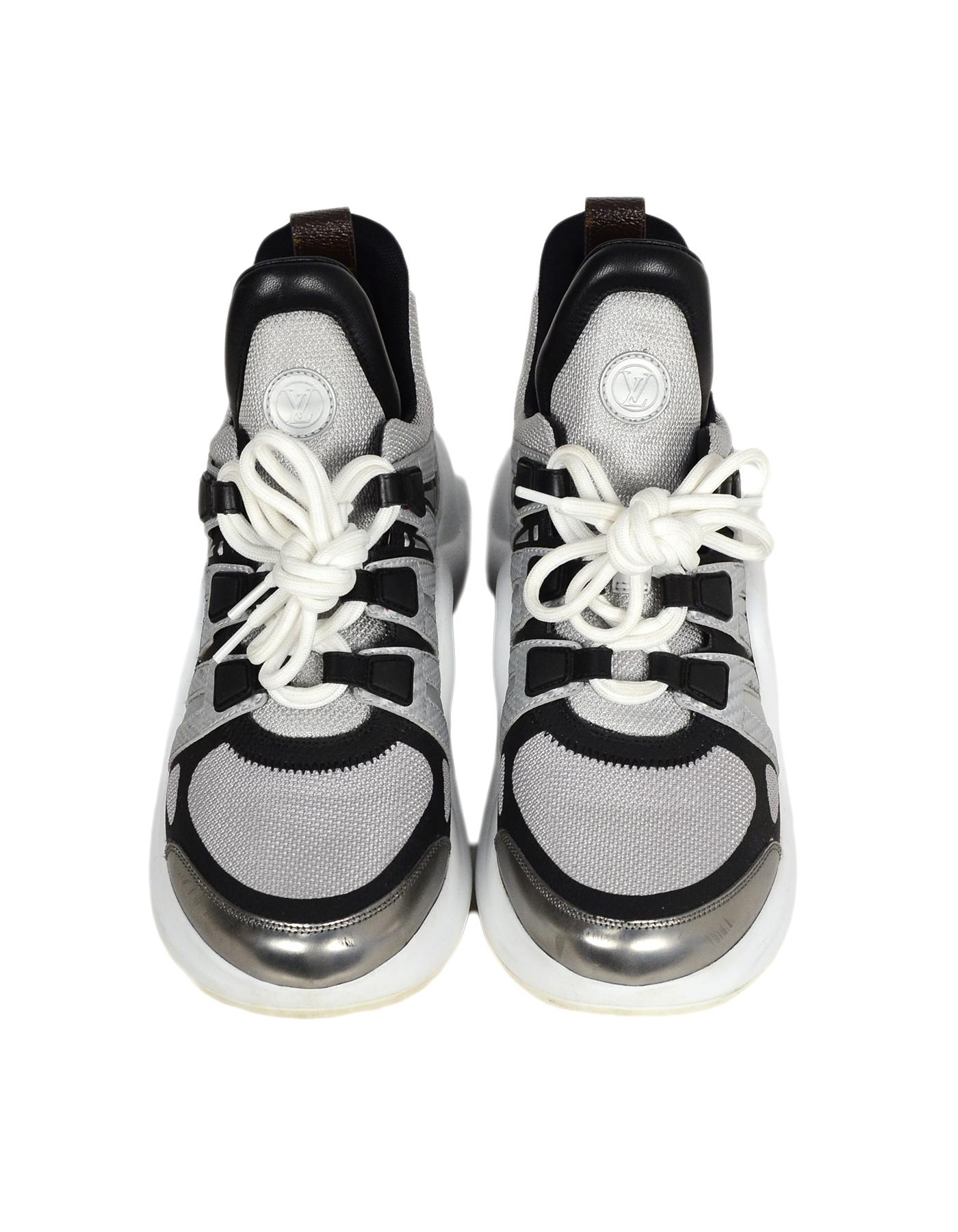 Louis Vuitton 2018 Archlight Reflective Sneakers sz 39

Made In: Italy
Year of Production: 2018
Color: Silver, black
Materials: Nylon, rubber, coated canvas trim
Closure/Opening: Lace-up
Overall Condition: Very good pre-owned condition, with the